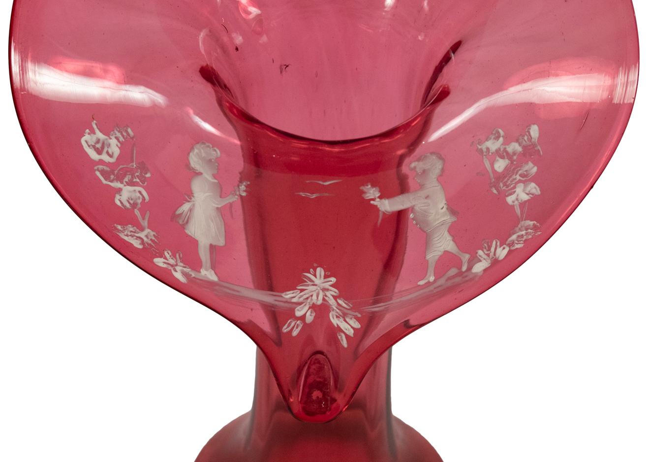 A finely decorated Mary Gregory cranberry glass jack-in-the-pulpit style vase.
  