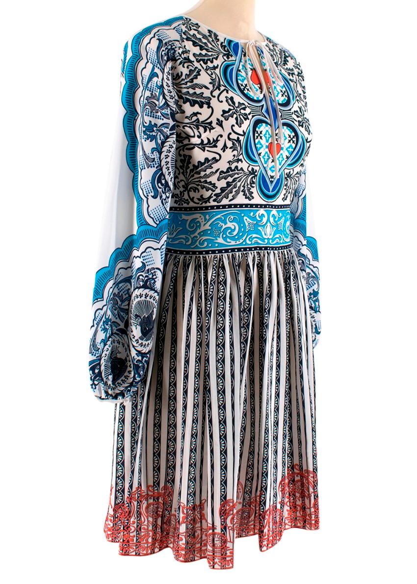 Mary Katrantzou Patterned Tie Neck Dress

- Puff sleeves
- Synched waist
- Very lightweight and flowy
- Pleated skirt
- Button cuff
- Hidden zip with hook and eye fastening
- White with blue stripes and red highlights

Material
- 100% silk
- Dry