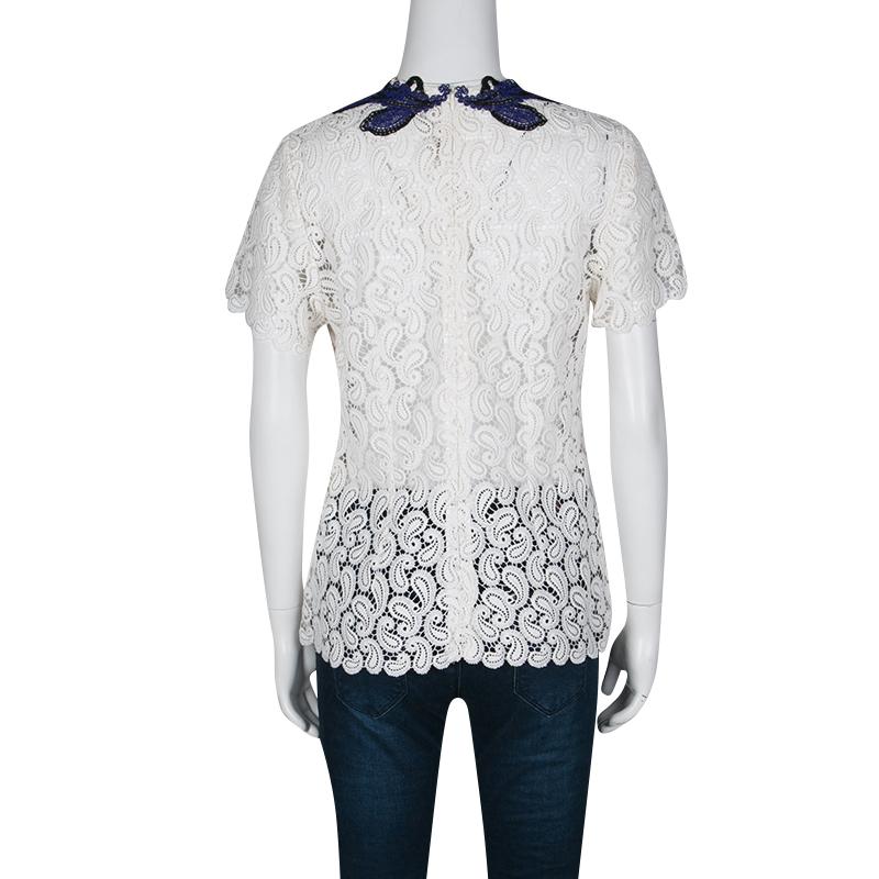 Mary Katrantzou was inspired by classic motifs for their Pre-fall Winter 2015 collection. This top is crafted with white guipure lace lending a beautiful feminine touch to the piece. The neckline is embellished with royal blue and black paisley