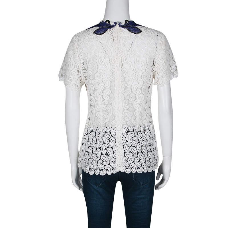 Mary Katrantzou was inspired by classic motifs for their Pre-fall Winter 2015 collection. This top is crafted with white guipure lace lending a beautiful feminine touch to the piece. The neckline is embellished with royal blue and black paisley