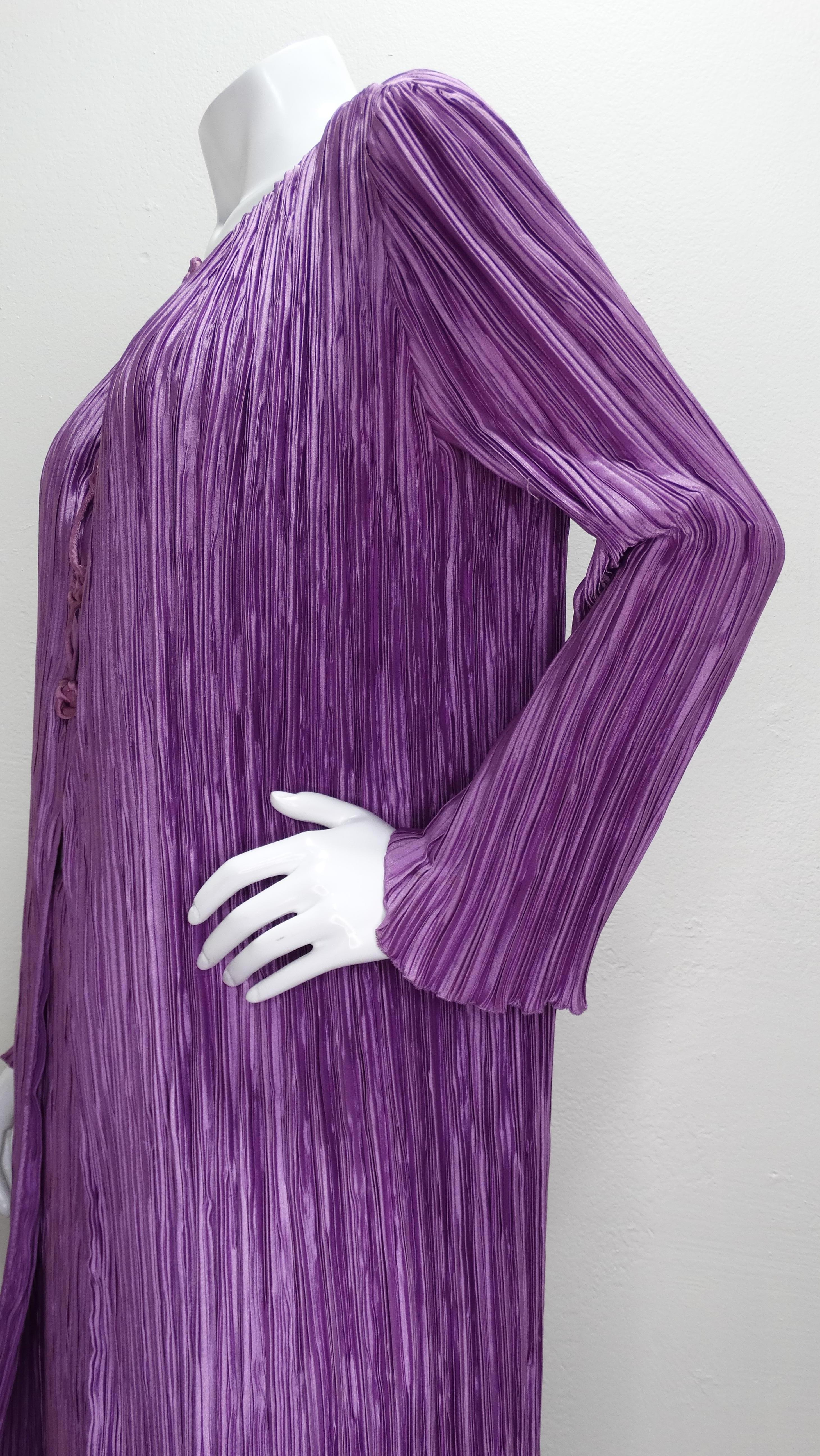 Look breezy and effortless in this beautiful 1980s Mary McFadden two piece outfit! Made of 100% silk fabric in a rich shade of purple, this look features a pleated asymmetrical jacket with knotted hook and eye closure buttons down the front and a