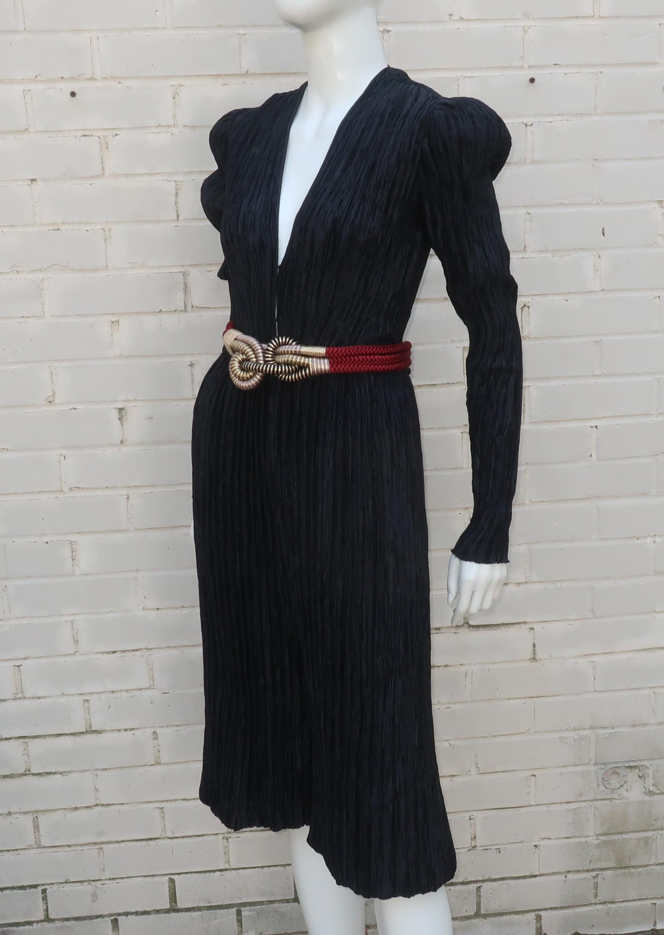 Fun and fabulous 1970’s Mary McFadden black romper jumpsuit with exotic braided belt.  The jumpsuit zips at the front to the waist and has a collarless plunging neckline with hidden hooks, if modesty is required.  The design is executed in