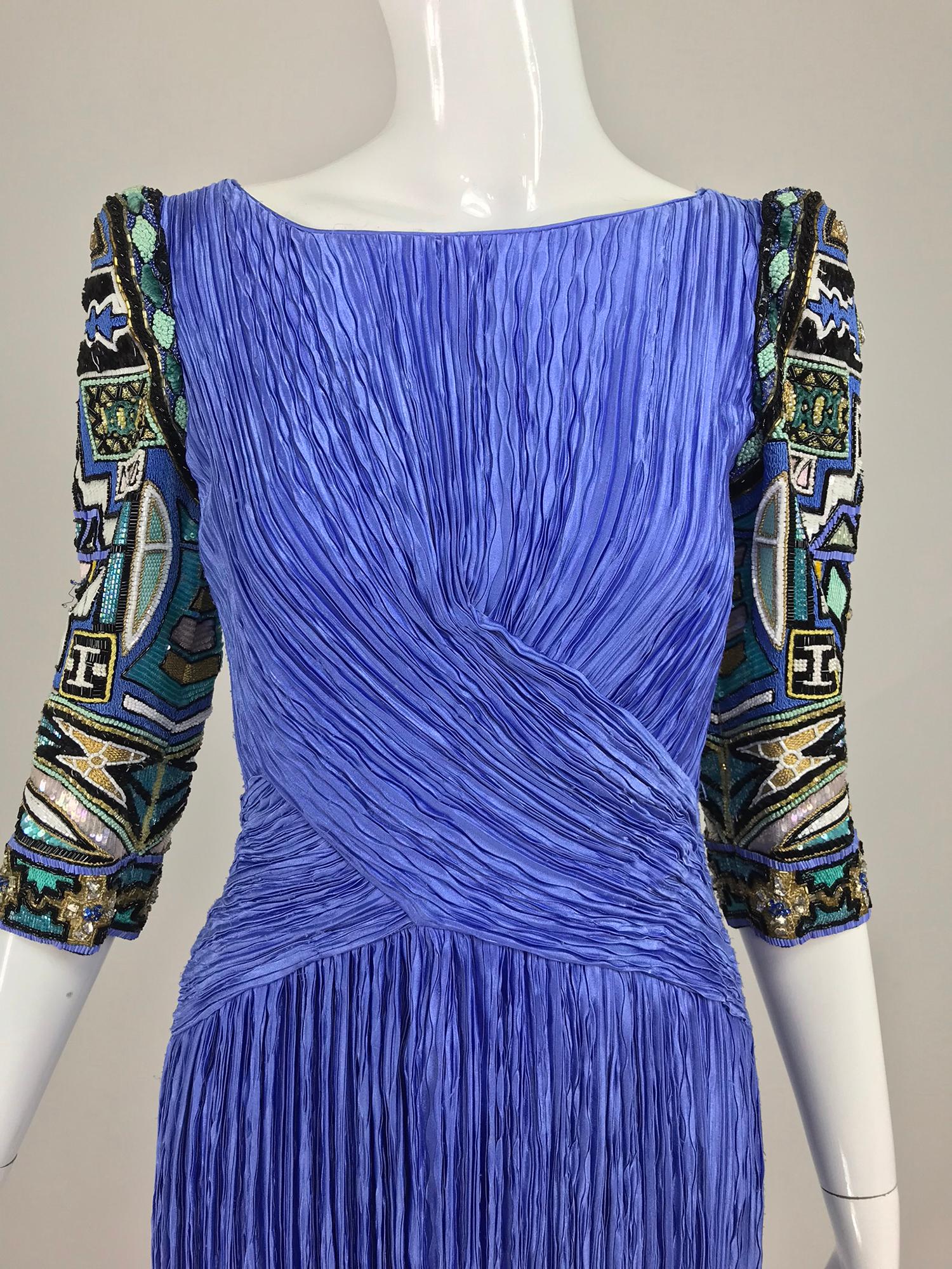 Mary McFadden Couture art beaded pleated evening gown in blue from the 1980s. This beautiful gown in a shade of blue like cornflower, has the most amazing beaded sleeves. It is an earlier gown and the sleeves are peaked at the shoulder so there is