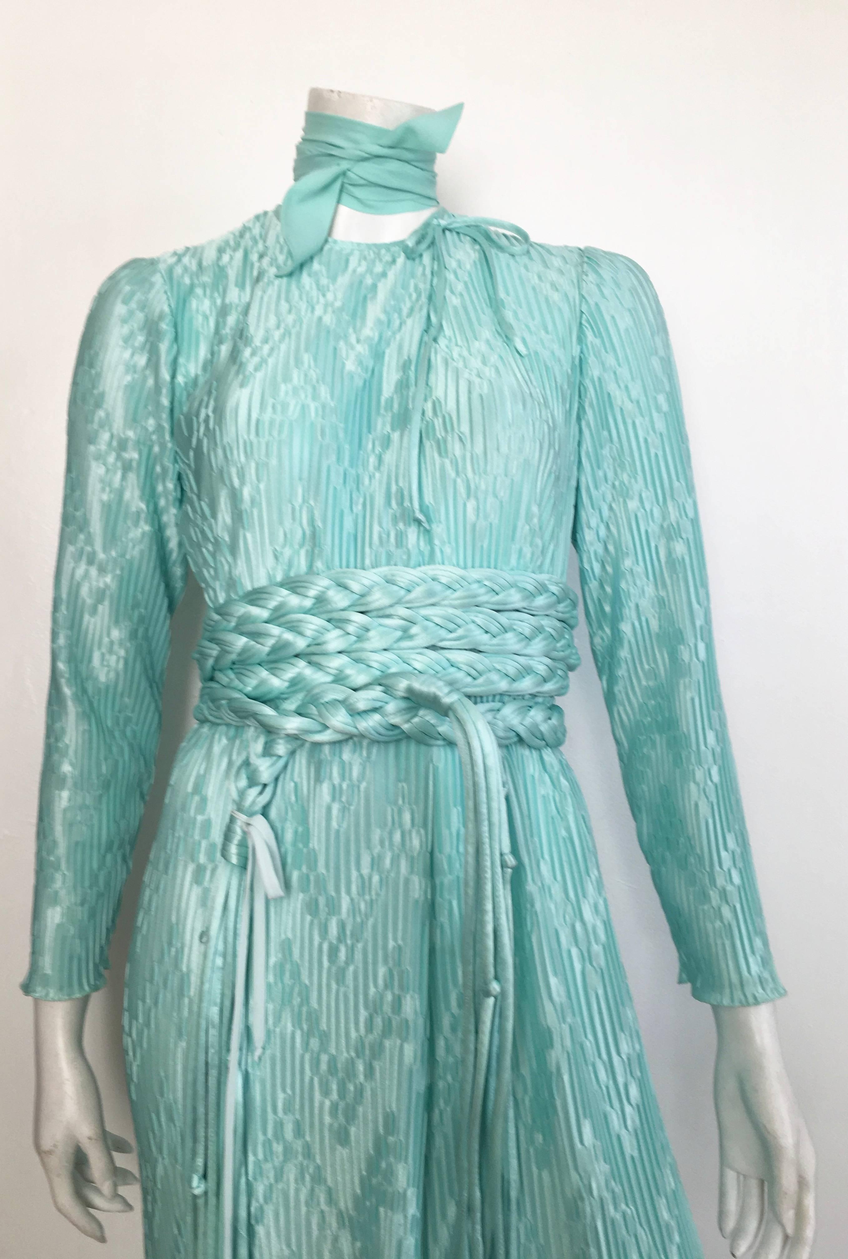 Mary McFadden for Bonwit Teller 1970s aqua maxi dress with braided fringe belt is labeled a size small but ideally a size 6 would be perfect.  This dress was designed to be oversized and flowing, not tailored fit. Not only is the aqua color stunning