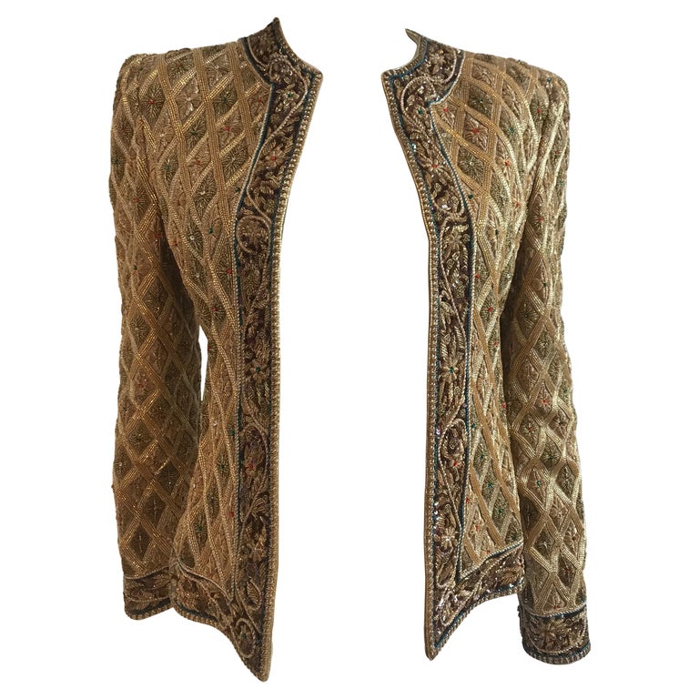 Mary McFadden Gold Embroidered Beaded Jacket with Metal Strip Work. Cross hatched pattern with floral embroidered beaded border. 
Size US 2-4
Made in the US