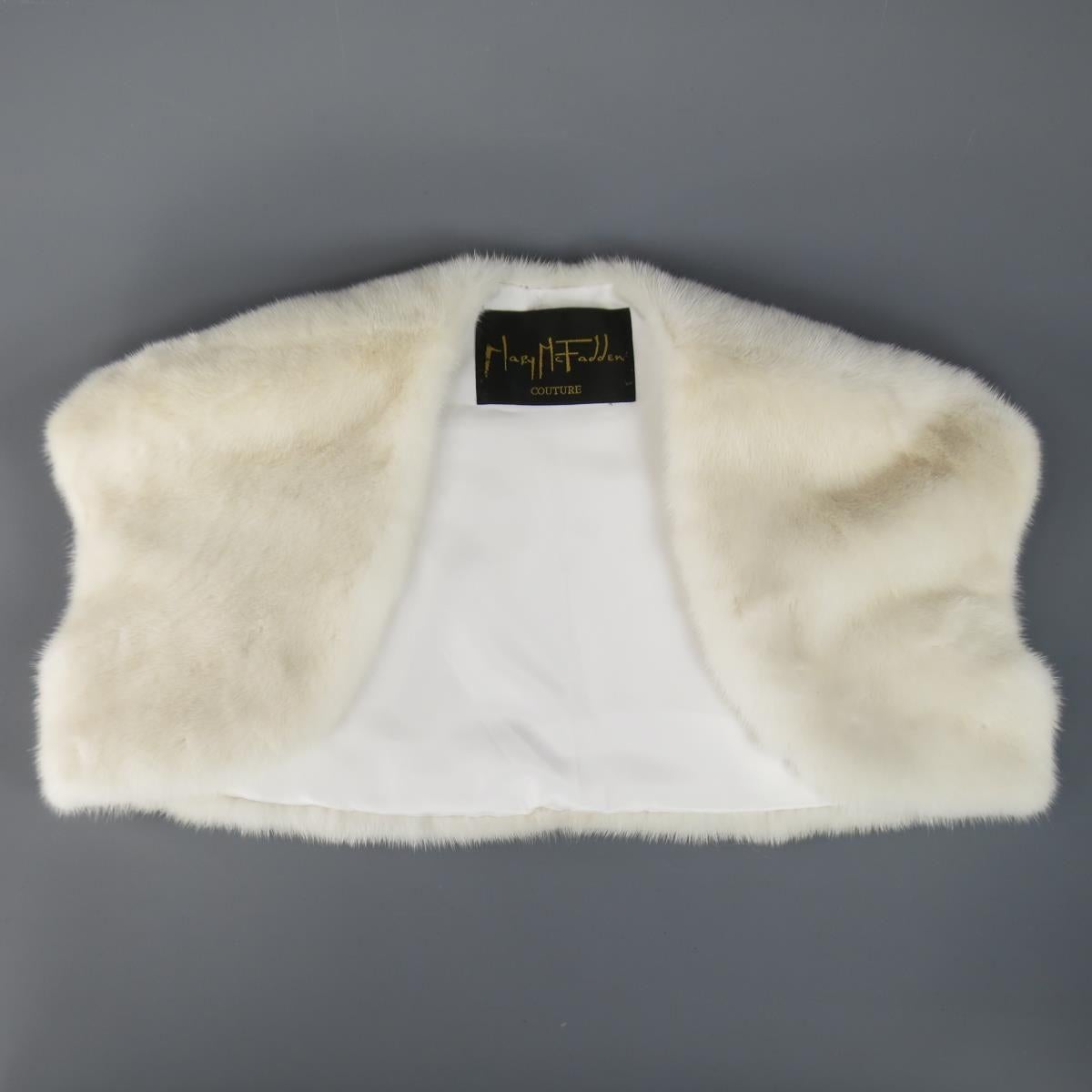 Chic MARY MCFADDEN cropped bolero shrug in off white cream mink fur with satin lining. Made in USA.
 
Excellent Pre-Owned Condition.
 
Measurements:
 
Shoulder: 19 in.
Bust: 36 in.
Length: 11 in.
