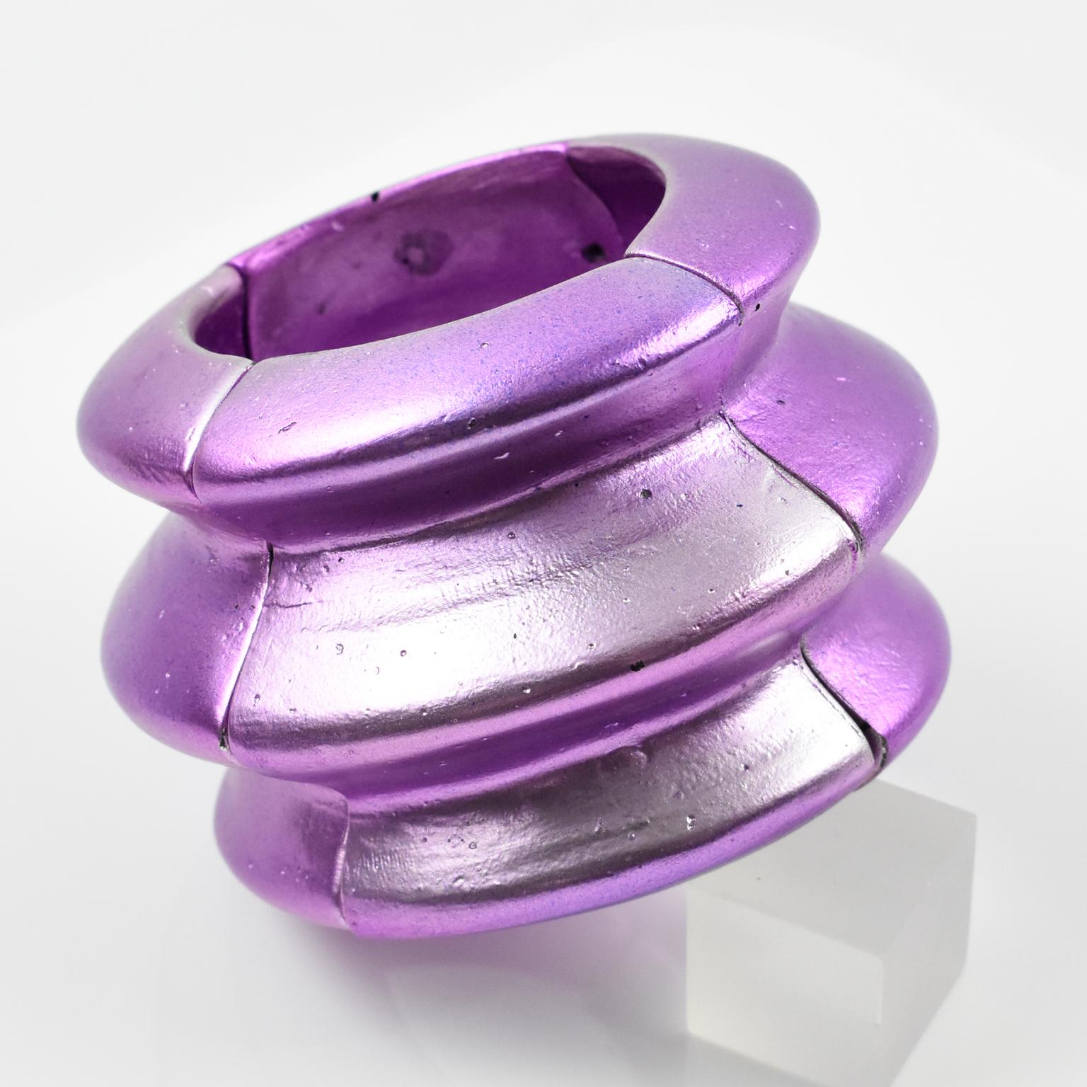 A sophisticated oversized bracelet bangle created by American artist Mary Oros. Features extra-large organic feel cast resin with an incredible purple-violet metallic coating with tone variation, built on a stretch link. This piece is not signed,