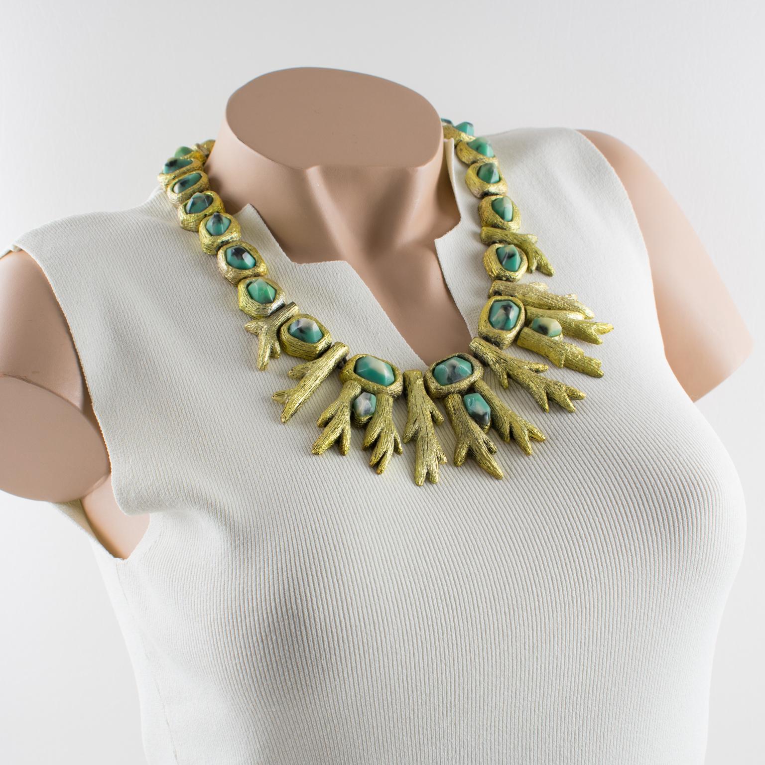 Bay area artist and sculptor Mary Oros created this bold sculptural necklace in the 1980s. The choker features an organic feel of branches shaped in cast resin with gilded metal coating topped with turquoise blue, white, and black resin cabochons.