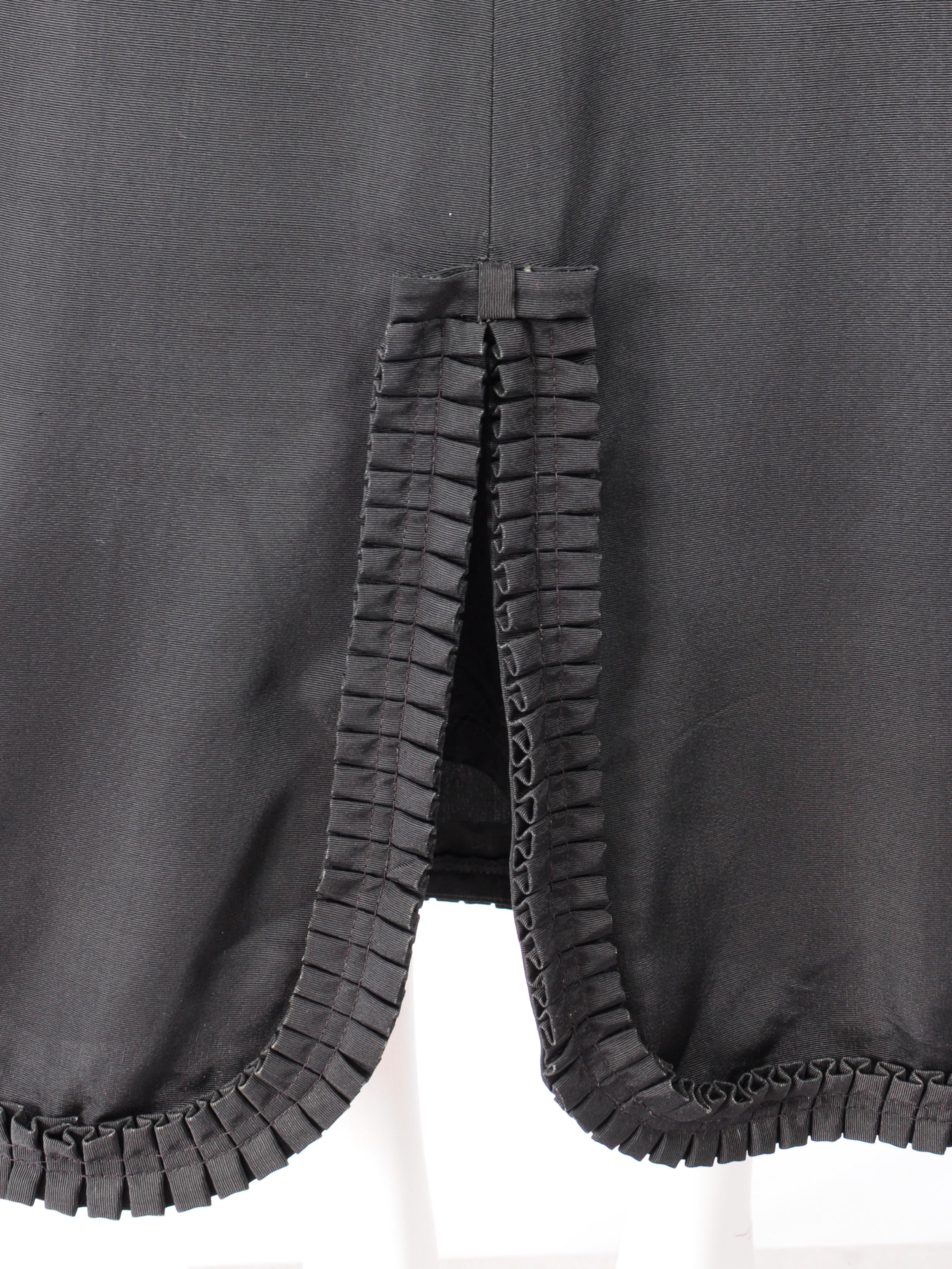 Mary Quant Ginger Group maxi skirt in black from the 1960s with A-Line silhouette and ruffle and bow bottom hem. La jupe se situe au niveau de la taille et s'évase à partir de celle-ci. Cette jupe ligne A de Mary Quant est une pièce d'archive datant