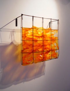 Southern Sunset, a glass and metal orange wall sculpture by Mary Shaffer