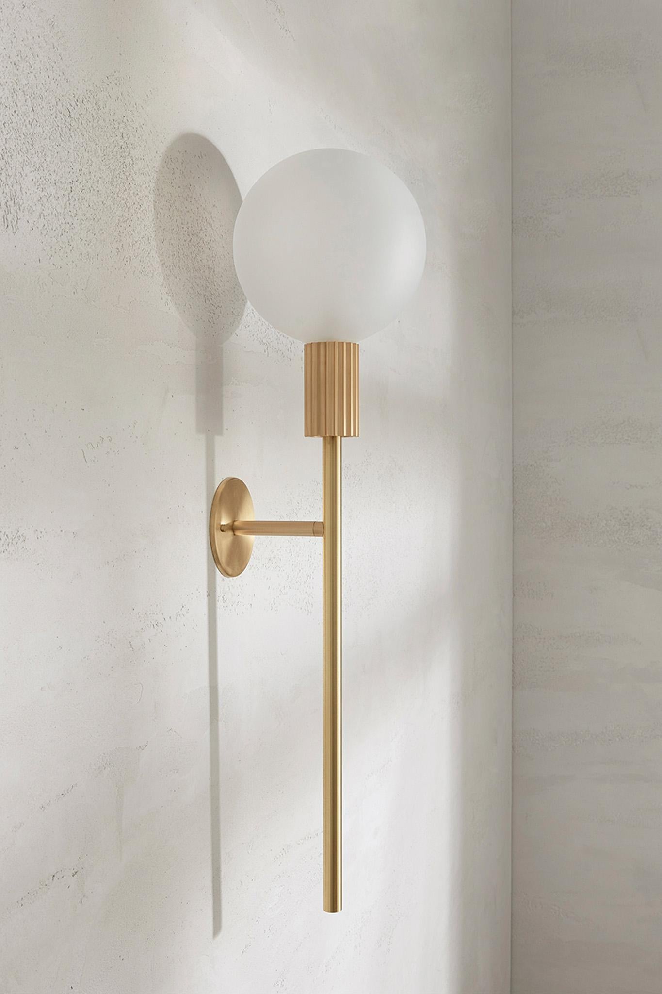 The Attalos Wall Light, 200 is a new addition to the current Attalos range and retains its classical sculptural aesthetic echoing ancient Greek architectural forms. Incorporating an LED frosted globe counterbalanced on a base and post machined from