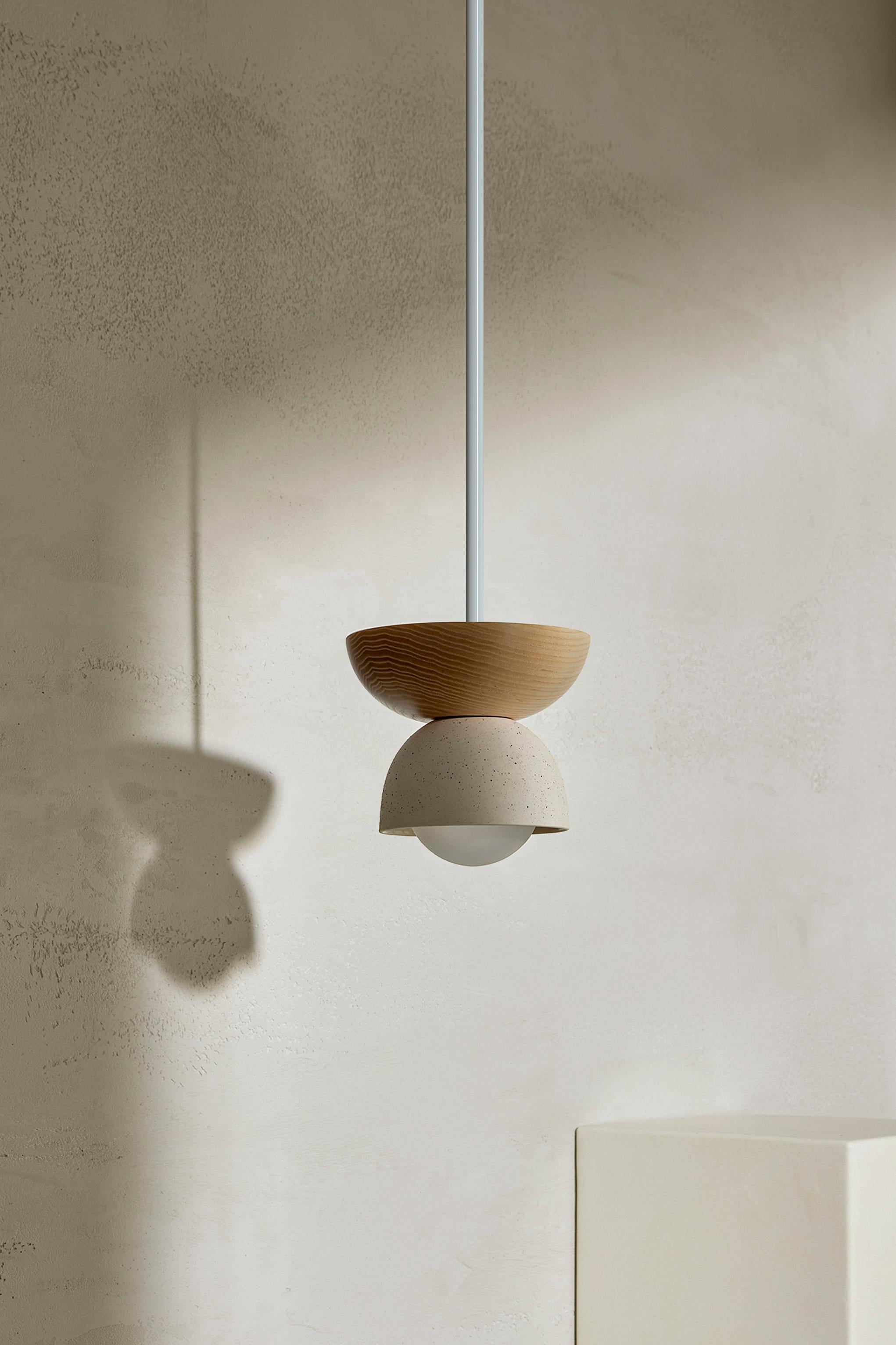 Crafted with a combination of two contrasting half domes, Terra 00 is available in pendant light, wall and ceiling-mounted formats. The Terra 00 Pendant Light is made up of a slip-cast ceramic shade, paired with hand-turned FSC-certified timbers,