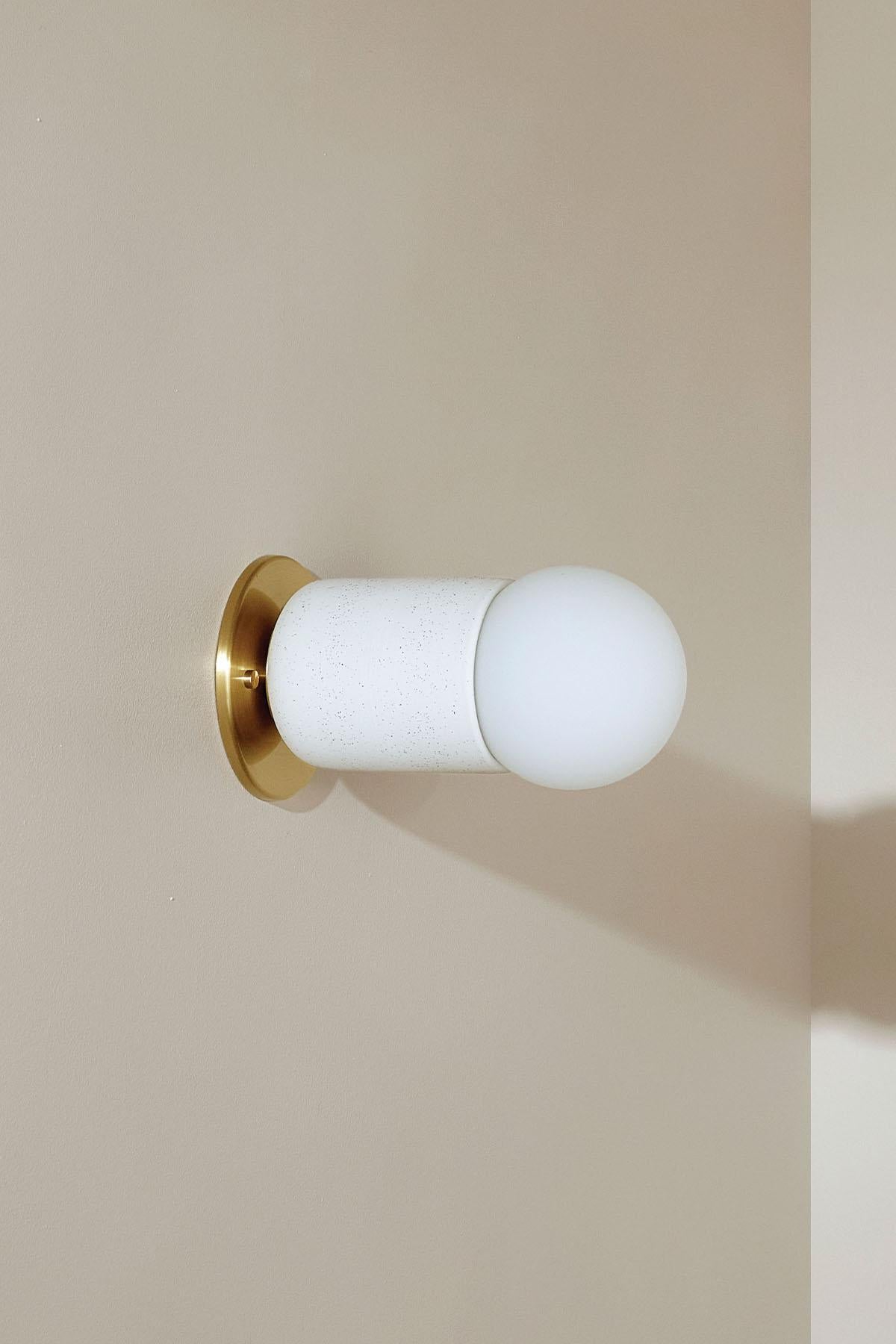 Simple cylindrical ceramic forms define the Terra 1 range, which comes in pendant light, wall light, and in long and short articulating wall light formats. The Terra 1 Surface Sconce, Slim Base is available in a choice of three tones – Slate, Sage