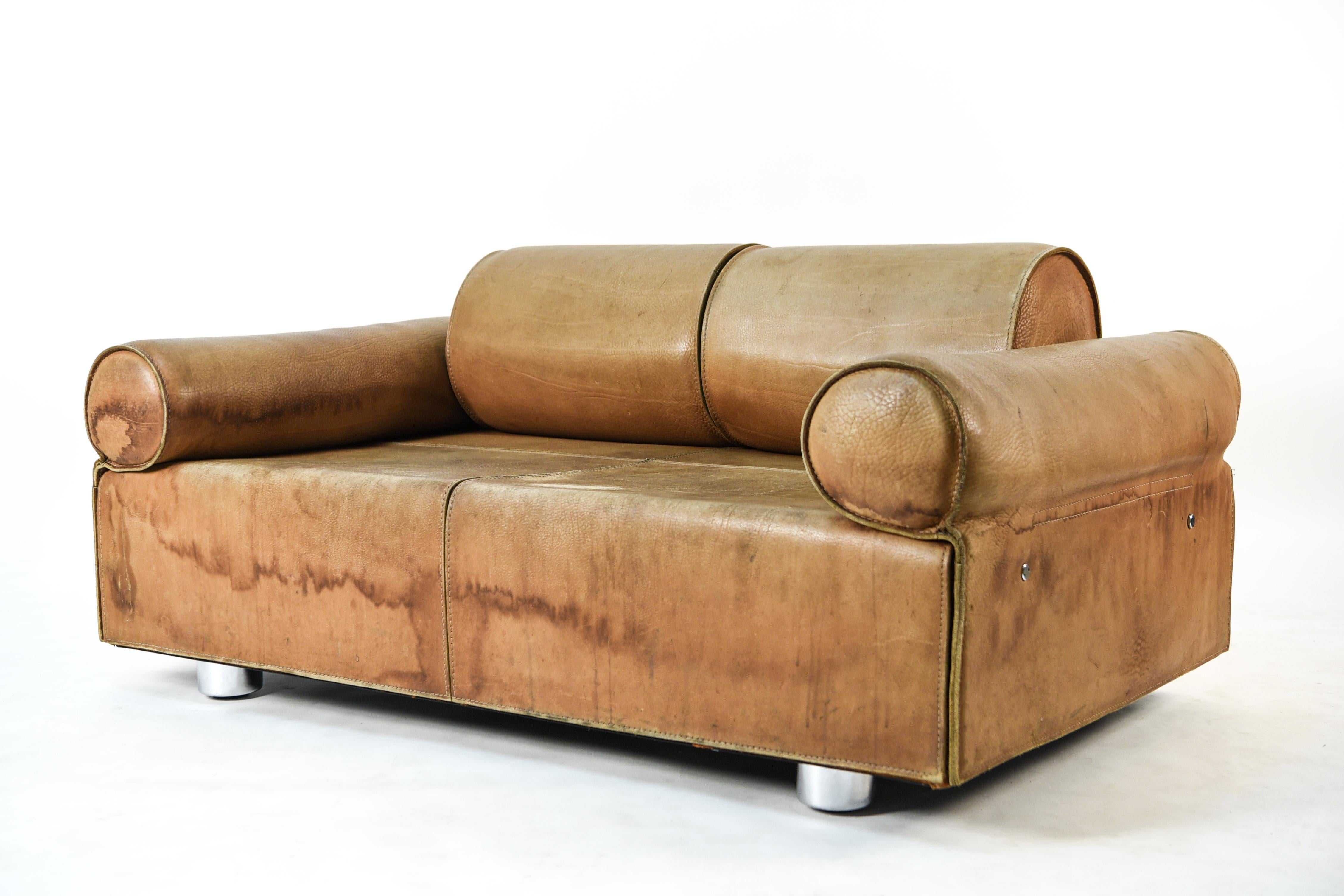 This is a very rare two-seat sofa or loveseat by Italian designer Marzio Cecchi, circa 1970. This piece has been upholstered in brown buffalo leather which has acquired a tasteful patination from age and use. The sofa design consists of spherical