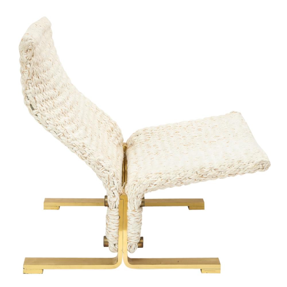 Marzio Cecchi lounge chair and ottoman, brass and woven rope. Large, wide, and heavy woven lounge chair and ottoman with a brass plated steel base. The wool is an off-white or cream color with subtle orange threads. There are two very minor black