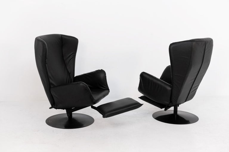Eccentric pair of Marzio Cecchi armchairs in black leather from the 1970s. 
The pair of armchairs have been recently restored. The armchairs have several particularities, noteworthy are its ears above its backrest. Another note is its removable