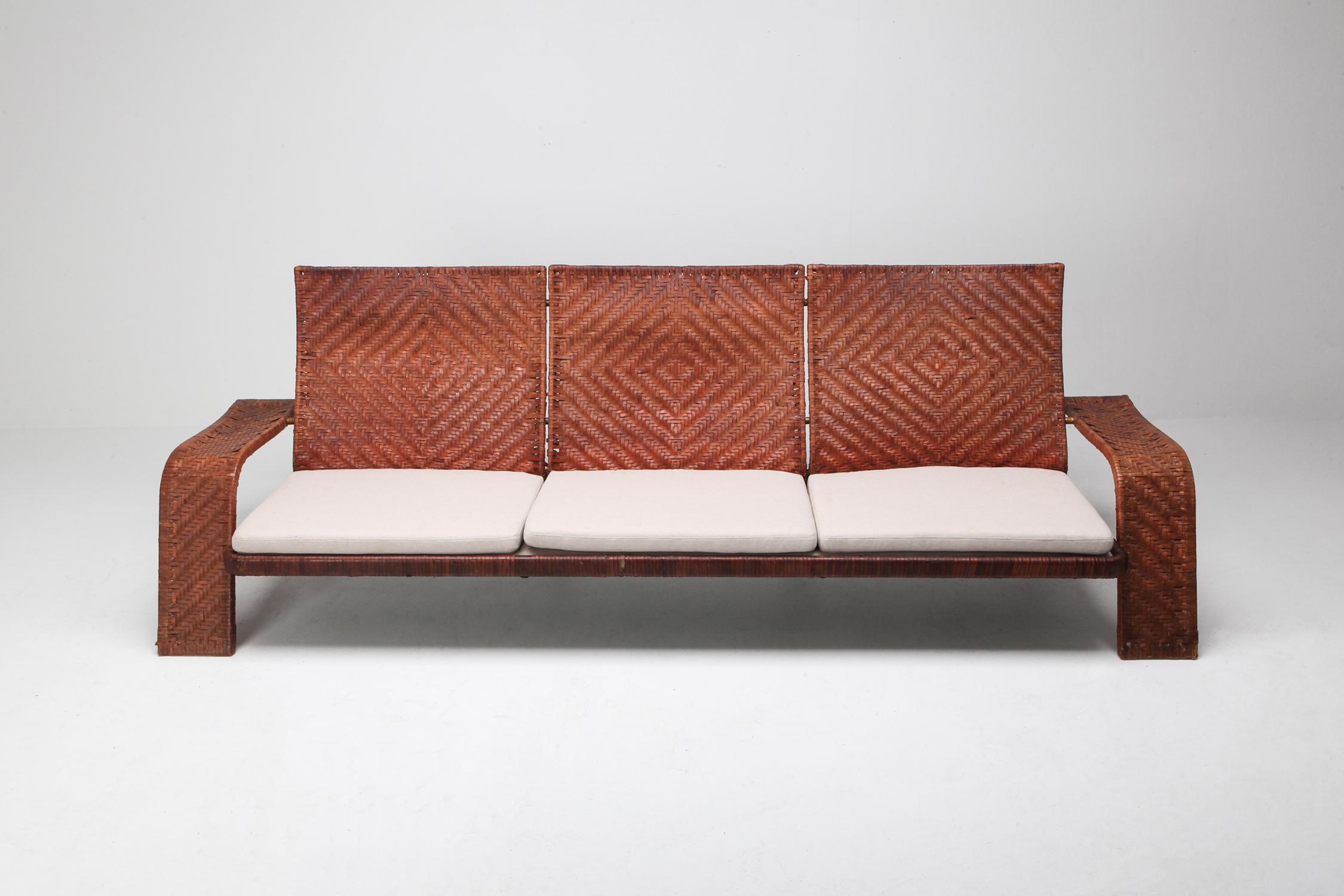 Post-modern three-seat couch by Marzio Cecchi for Studio Most.

Woven leather frame in diamond patterns finished with brass details.
finished with newly upholstered linnen cushions.
High end and custom made piece with amazing patina.
This couch