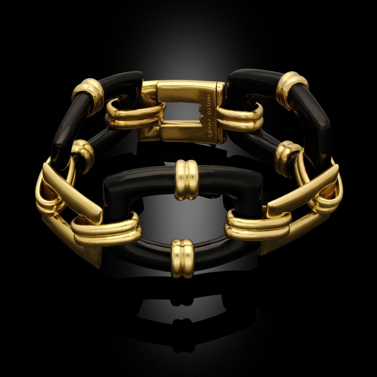 A Retro 18ct yellow gold and onyx bracelet by Georges Lenfant for Marzo, circa 1950. The bracelet is made up of alternating 18ct yellow gold and polished black onyx rectangular panels and connect with a concealed tongue and clasp.
Maker
Marzo -
