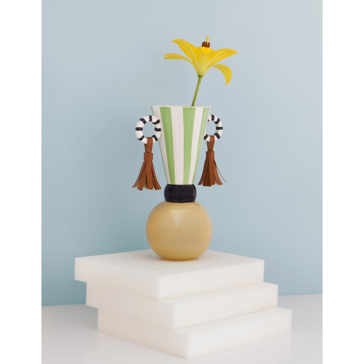 This striking vase is part of the Masai collection, inspired by the decorative elements of this African tribe that are interpreted in a modern way and exquisitely made into objects of functional decor. The ceramic body of this piece is handmade and