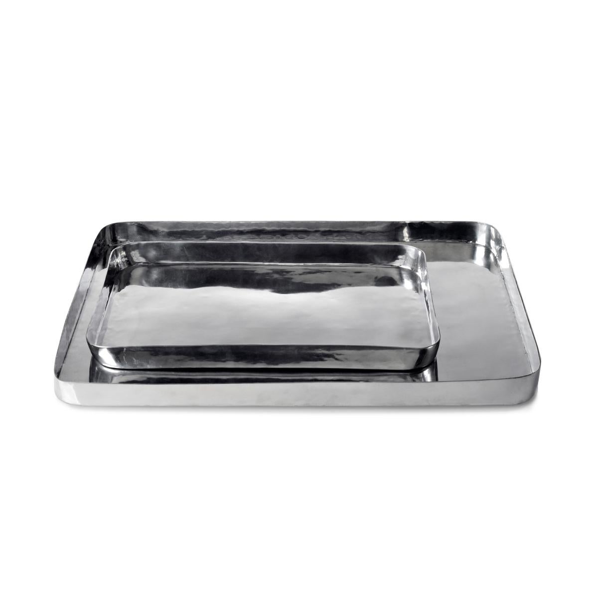 Masai is a family of rectangular polished metal trays designed by Aldo Cibic, available in two different sizes: small and large. The high edges and the rounded corner make this tray an handy object. The small one is perfect, for example, to serve