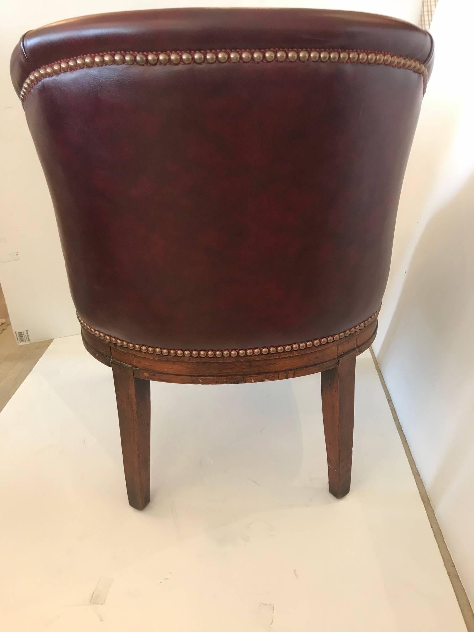 Very handsome English barrel shaped tub chair newly covered in rich burgundy leather and finished with brass nailheads.
Measure: Seat 20 D x 17.5 H.

 