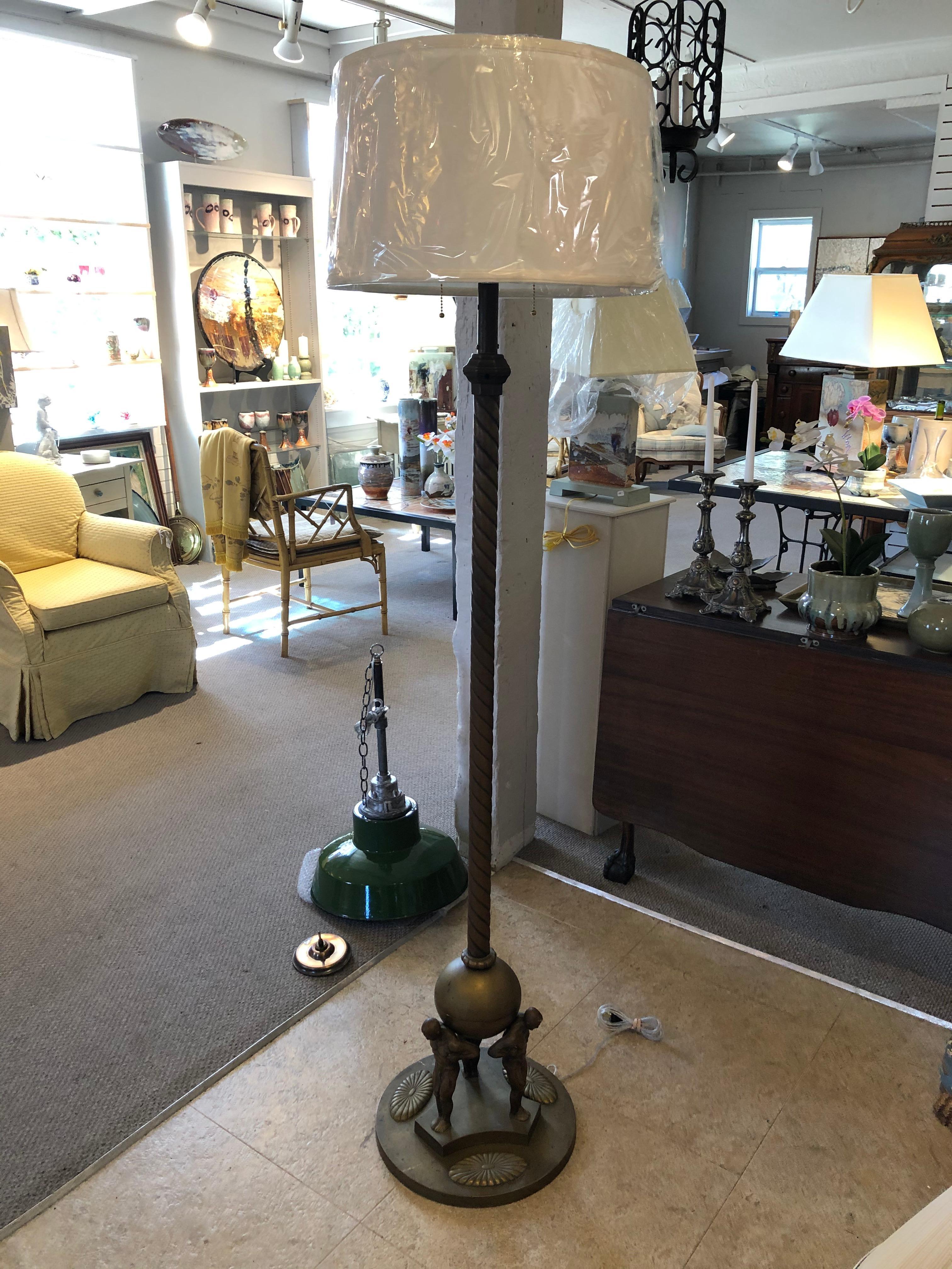 Beautiful and rare Art Nouveau Jugendstil floor lamp with 3 cast bronze Atlas style male nude sculptures around the base. This impressive and highly decorative floor lamp dates from 1910-1920. 
Measure: Diameter of base 14.5.