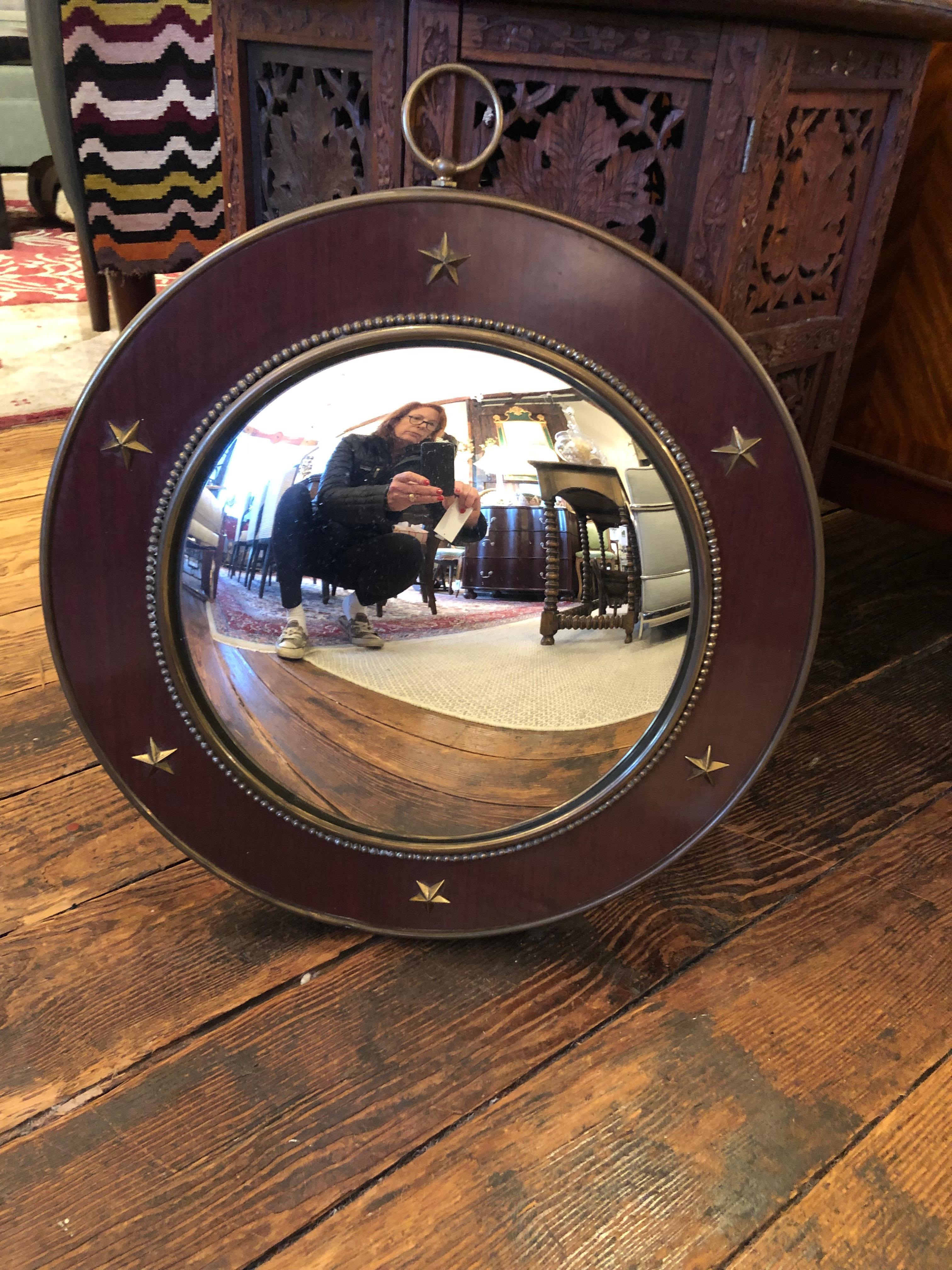 Handsome round convex mirror having mahogany frame with brass periphery and brass star embellishments.
mirror is 12