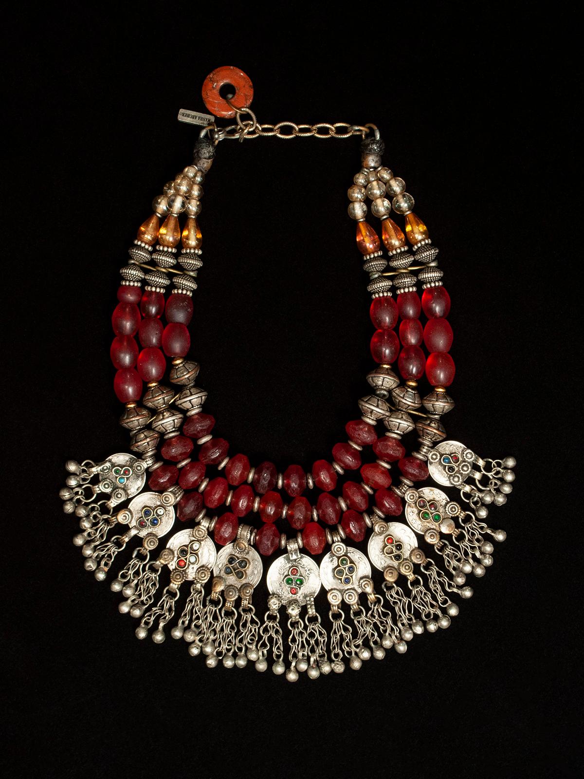 Masha archer silver, red and green tribal necklace
A festive red Bohemian glass bead necklace with Middle Eastern coins from the famed San Francisco jewelry designer Masha Archer. The interior circumference measures from 16 - 19 inches, depending