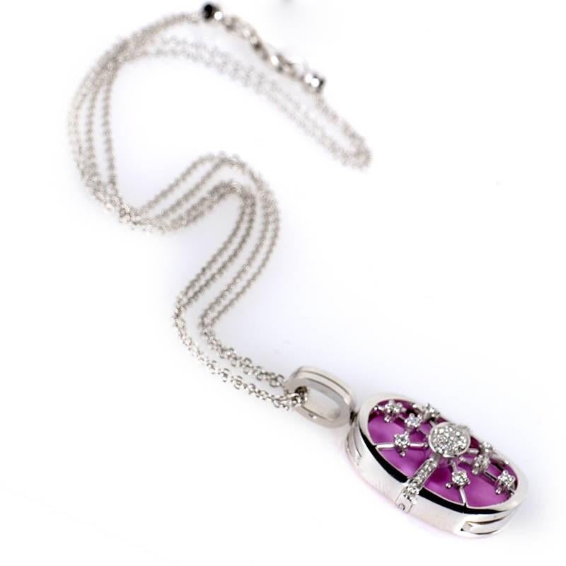 This pendant necklace from Masi Gioielli is colorful and shines with diamonds. The necklace is made of 18K white gold and boasts a hanging pendant accented with a pink enamel and ~.36ct of diamonds.
