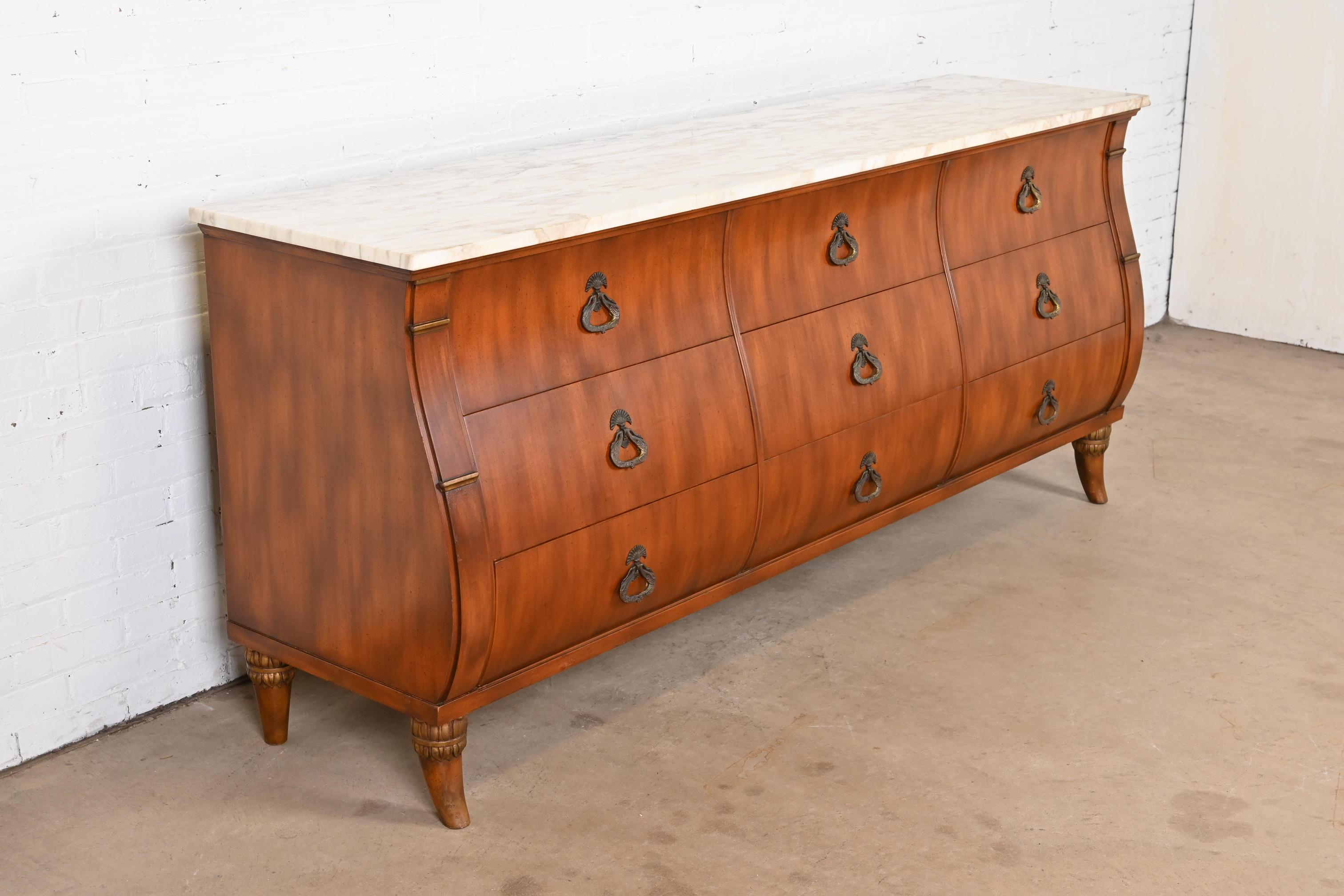An exceptional French Regency Louis XVI style long dresser or credenza

By Maslow Freen

USA, Circa 1940s

Walnut, with Carrara marble top, and original brass hardware.

Measures: 85