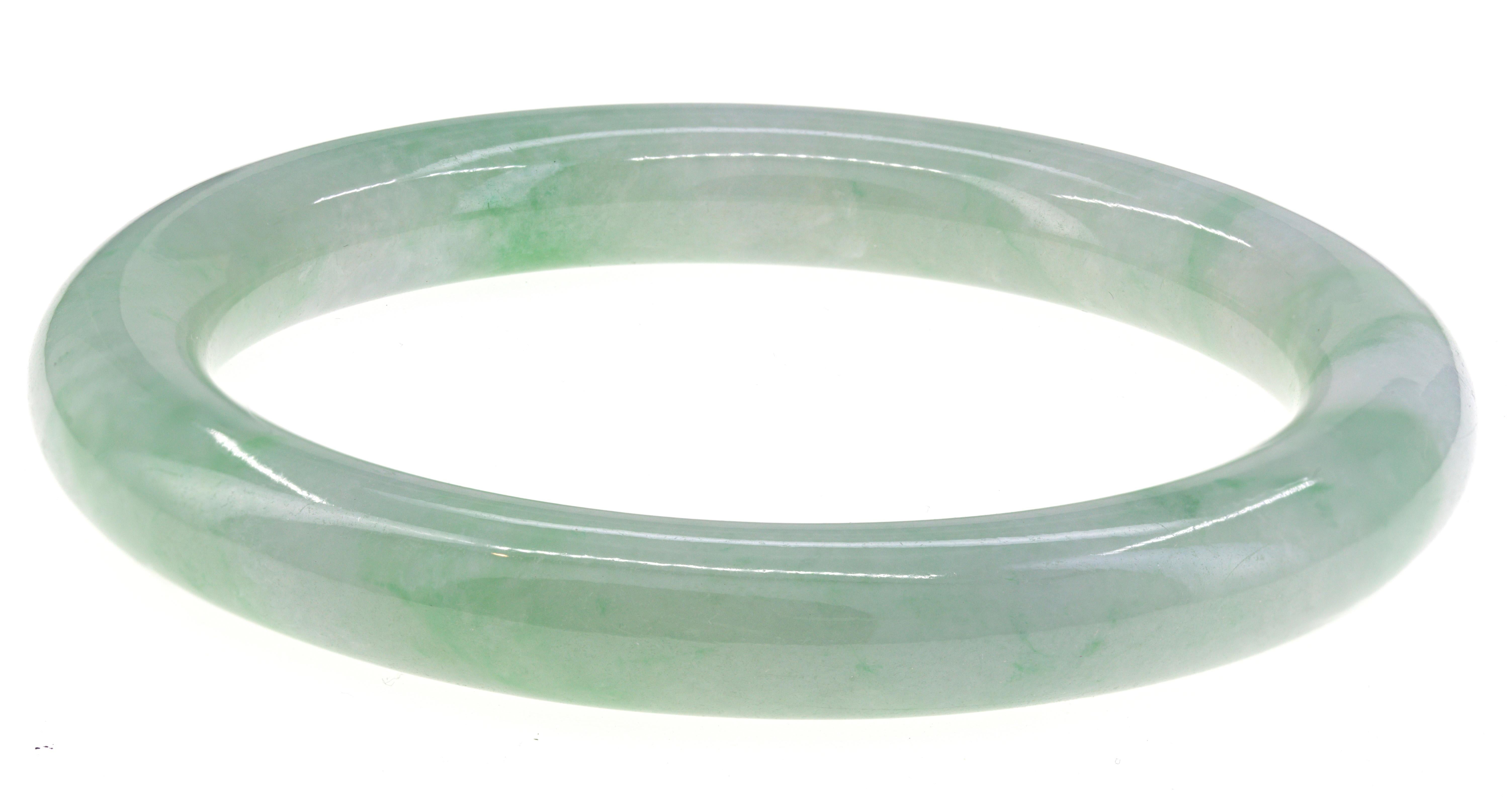 One carved natural untreated mottled green, semi-translucent, jadeite jade bangle bracelet, 78.98 X 59.05 X 9.67 mm, accompanied by a Mason Kay Authenticity Report #230624-5450, dated June 24, 2023, stating Natural Jadeite Jade - no dye or