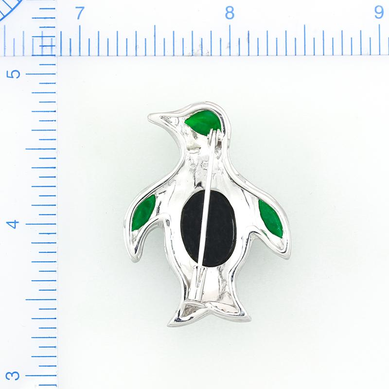This is a beautiful Designer Penguin Pin is set in 18K luxurious satin white gold that can also be worn as a pendant. An amazing fine natural green jadeite jade free-form stone (4.9 x 8.9 x 2.4mm) is used for the head of this adorable penguin. Two