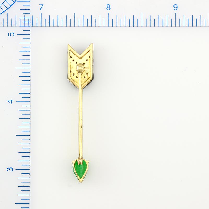 A Mason-Kay Original One-of-a-kind Design. Certified natural vivid apple green jadeite pear shaped cabochon (6x8mm) set in an 18K yellow gold arrow designed pin with pave diamond and onyx striping. The total diamond weight is .11cts.  

***
