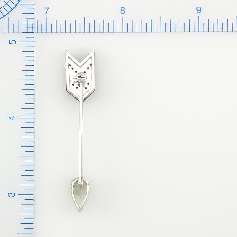 Too Fabulous! A Mason-Kay Original One-of-a-kind Design. Certified natural translucent ice jadeite pear shaped cabochon (6x10mm) set in an 18K white gold arrow designed pin with pave diamond and onyx striping. The total diamond weight is .11cts. 