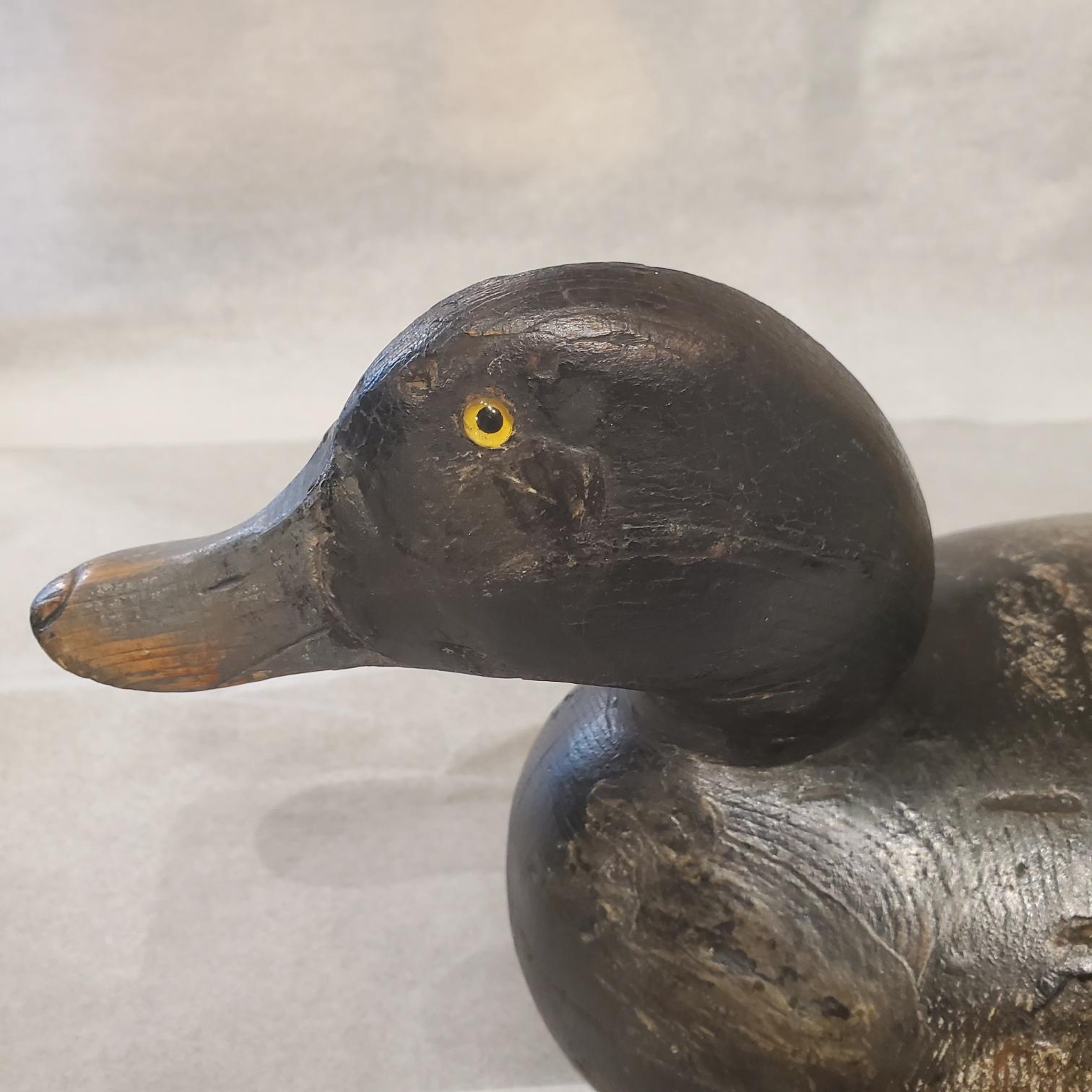 Antiguo señuelo Mason Premier Grade Bluebill Drake, circa 1920, con cabeza con ojos de cristal y mandíbula tallada, narinas y uña en el pico, unido a un cuerpo hueco tallado en dos partes (se ve la costura), con pintura original y algunos retoques