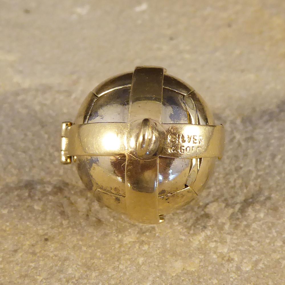 This Vintage Folding Ball Pendant appears initially to simply be a Gold sphere, however the four hinged arms open to show a cross shape formed by six pyramids. On these, are a variety of symbols including the tools of stonemasons to represent moral