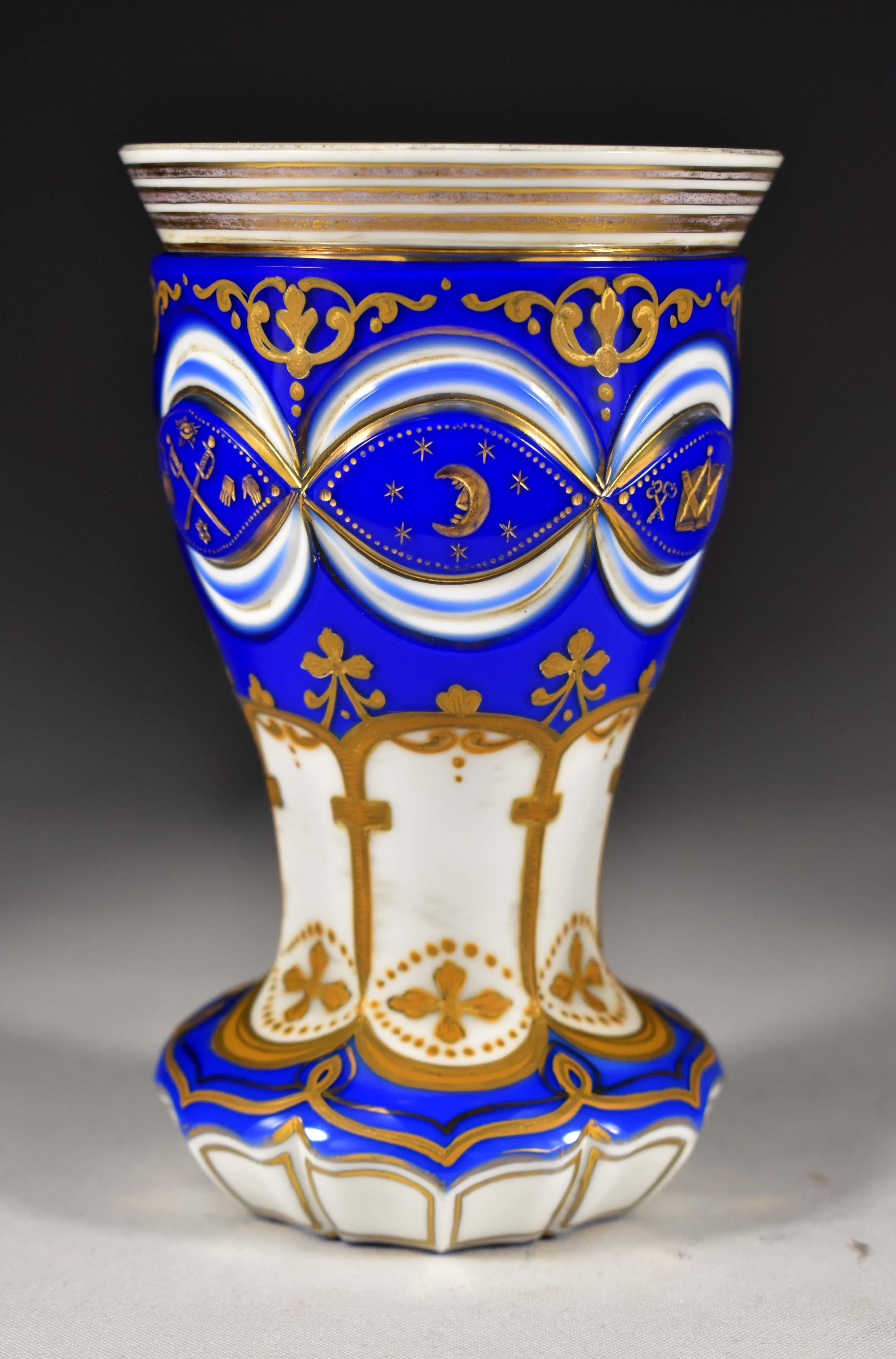 Antique overlay goblet, opal and cobalt glass.Goblet is Cut, engraved and painted, motif-symbolism of freemasons.The engraving is gilded and the painting is complemented with gold.There is also a gilded engraving with Latin inscriptions on the