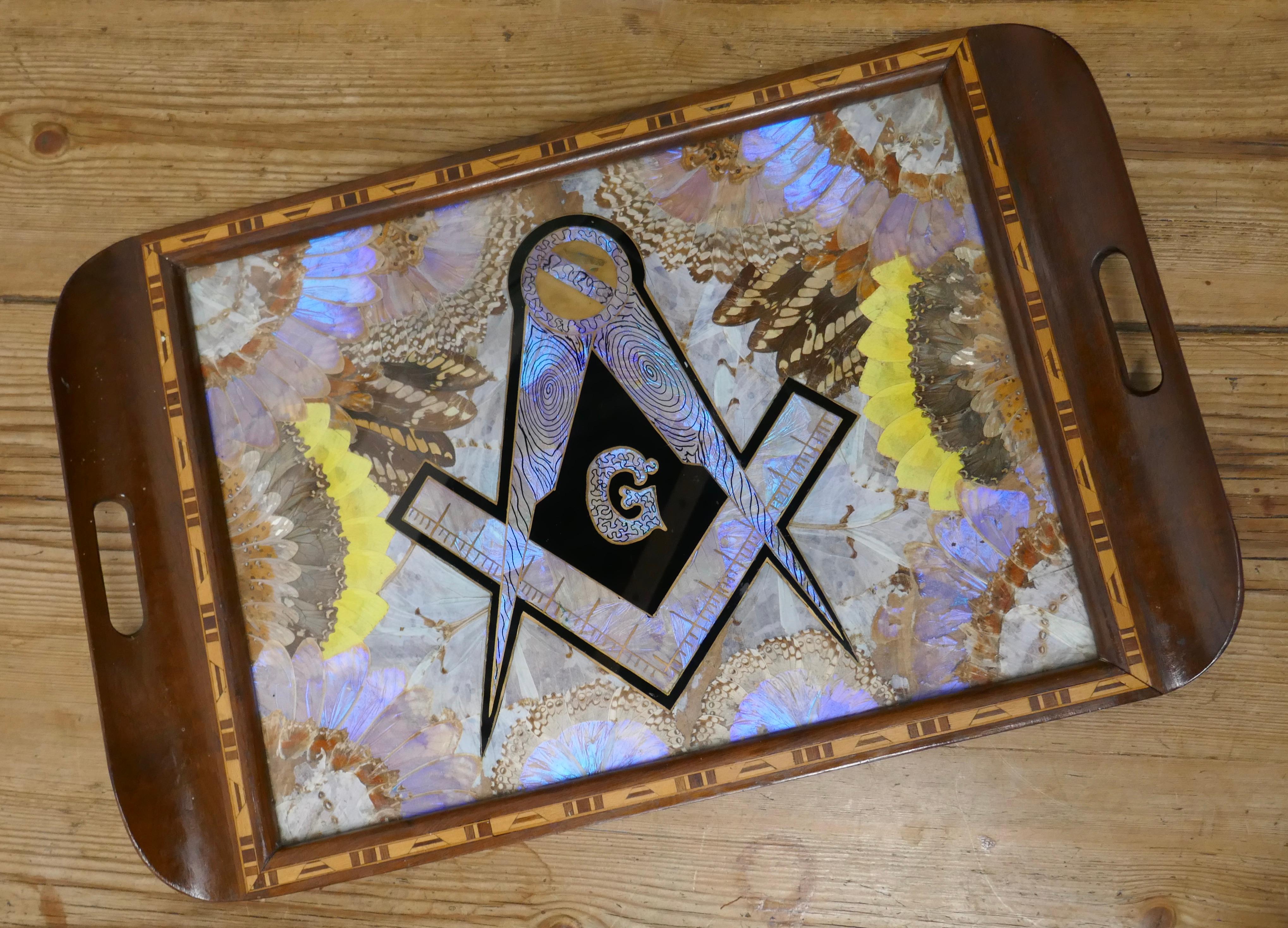 Masonic Tunbridge wear tray with butterfly wing decoration

A very impressive piece from the very early 20th century, with decorative Tunbridge wear border and colourful butterfly wings with a reverse painted Masonic emblem on the glass

The