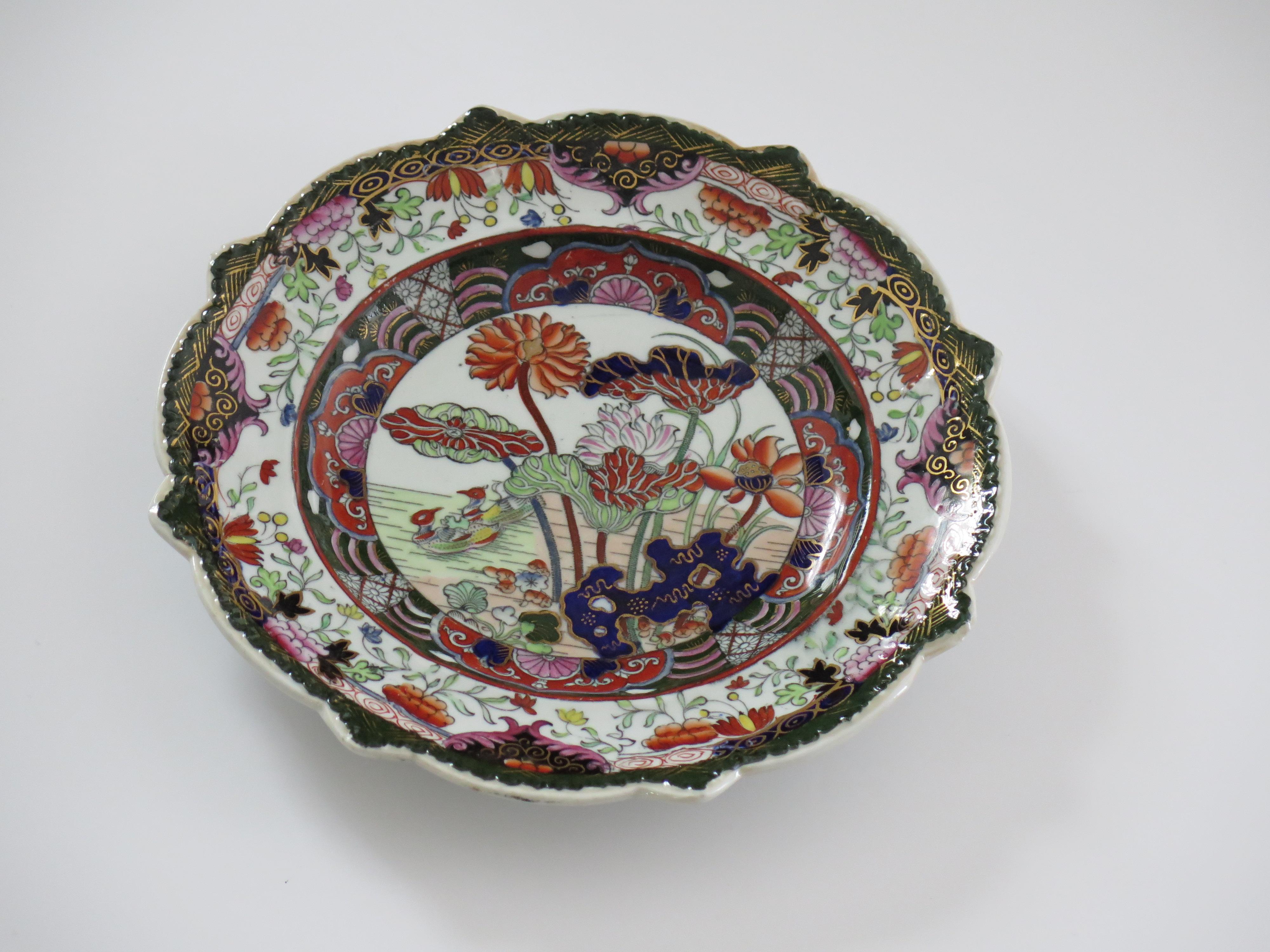 This is a beautifully hand painted shaped Plate in the rare Muscove Duck pattern by Mason's Ironstone, Lane Delph, England, dating to circa 1825.

The piece is well potted with a star shaped moulded rim .

The pattern is hand-painted and gilded