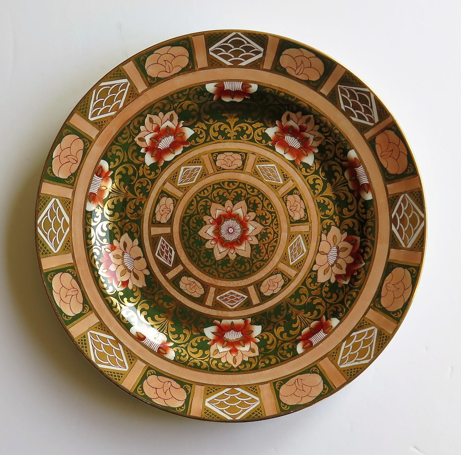 This is a late 19th century Mason’s ironstone large Dinner Plate in a striking heavily gilded pattern.

This large plate is decorated in a bold chinoiserie pattern that is very similar to the Central Flowers and Twirls pattern as documented and