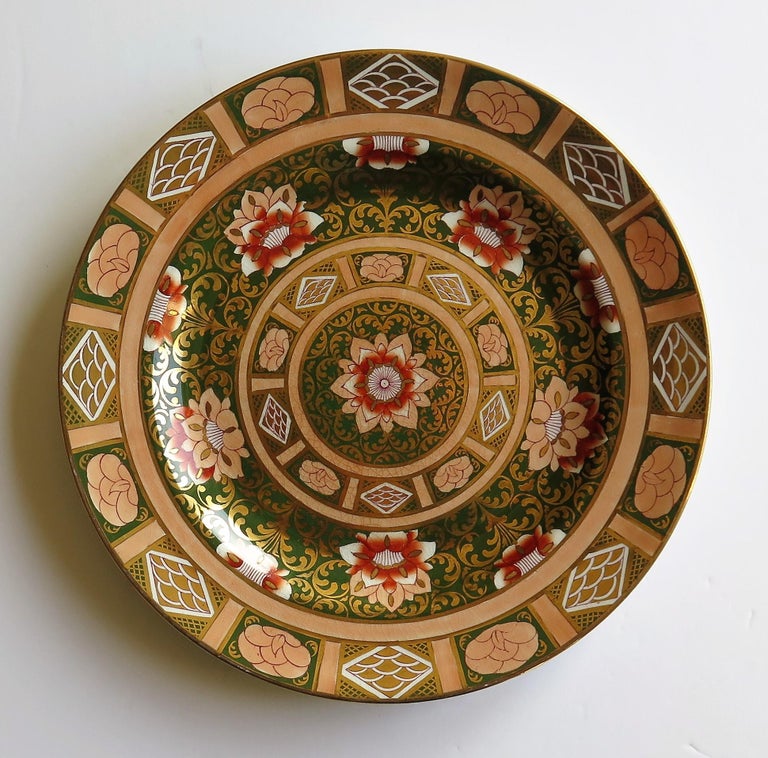 This is a late 19th century Mason’s ironstone cabinet plate in a striking heavily gilded pattern.

This large plate is decorated in a bold chinoiserie pattern that is very similar to the Central Flowers and Twirls pattern as documented and