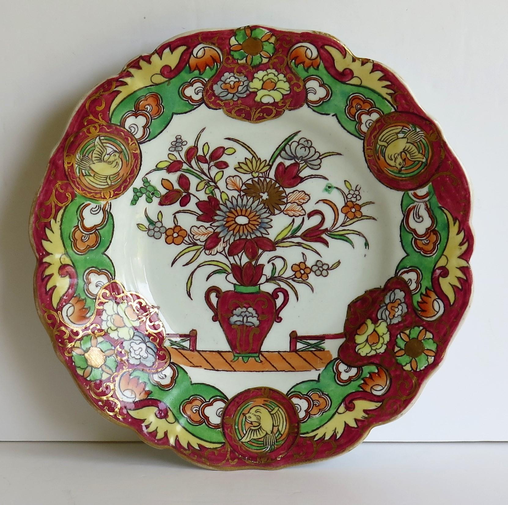 This is a very attractive desert dish or plate. Made by Mason's Ironstone Pottery, in the early 19th century, circa 1830.

The bowl is decorated in the fence, vase and doves chinoiserie influenced pattern, which shows a central flower filled vase,