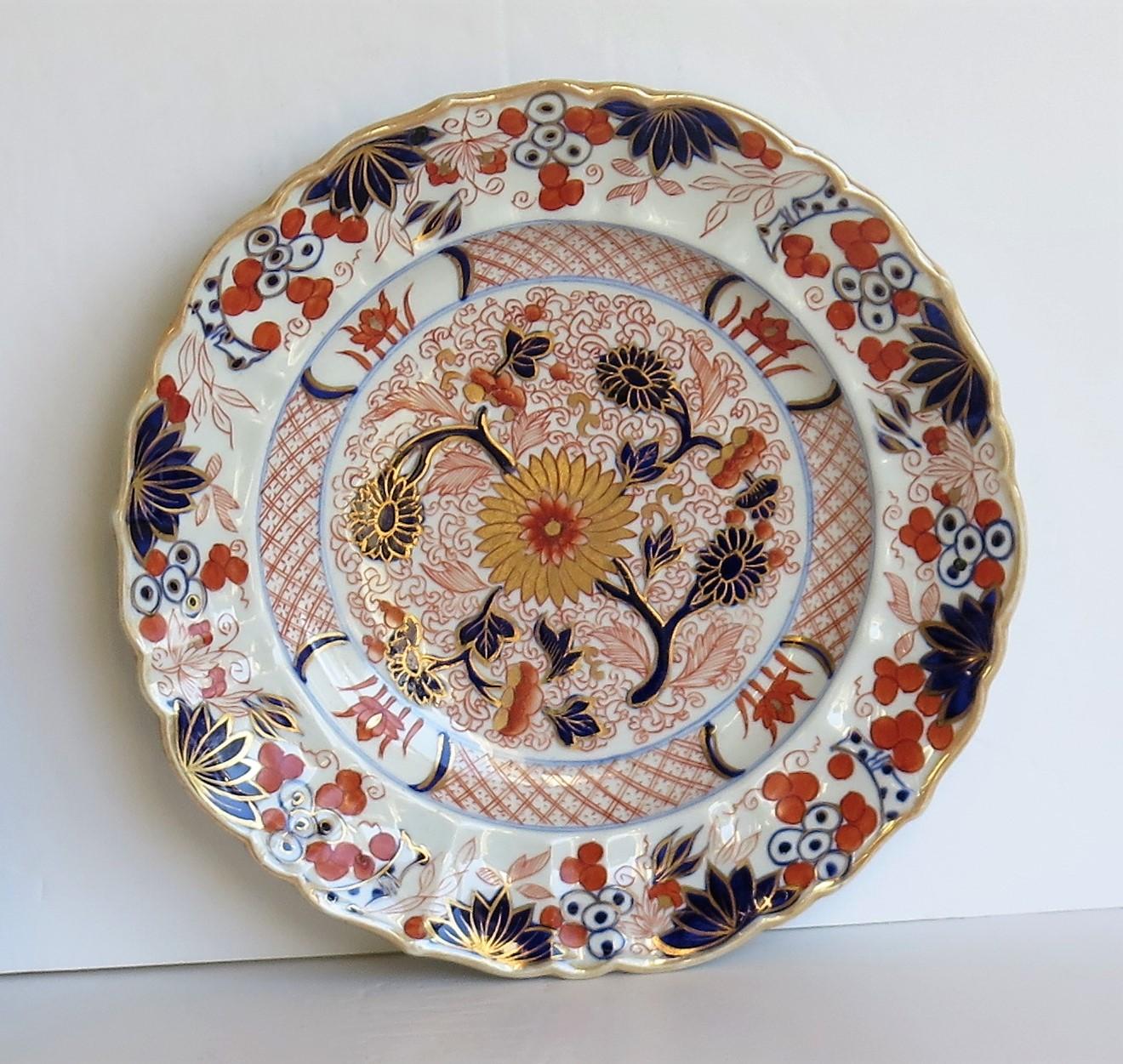 This is a very decorative, beautifully decorated ironstone pottery desert plate or dish in the gold Chrysanthemum pattern, produced by the Mason's Factory at Lane Delph, Staffordshire, England, circa 1818. This is a rare pattern.

The plate is