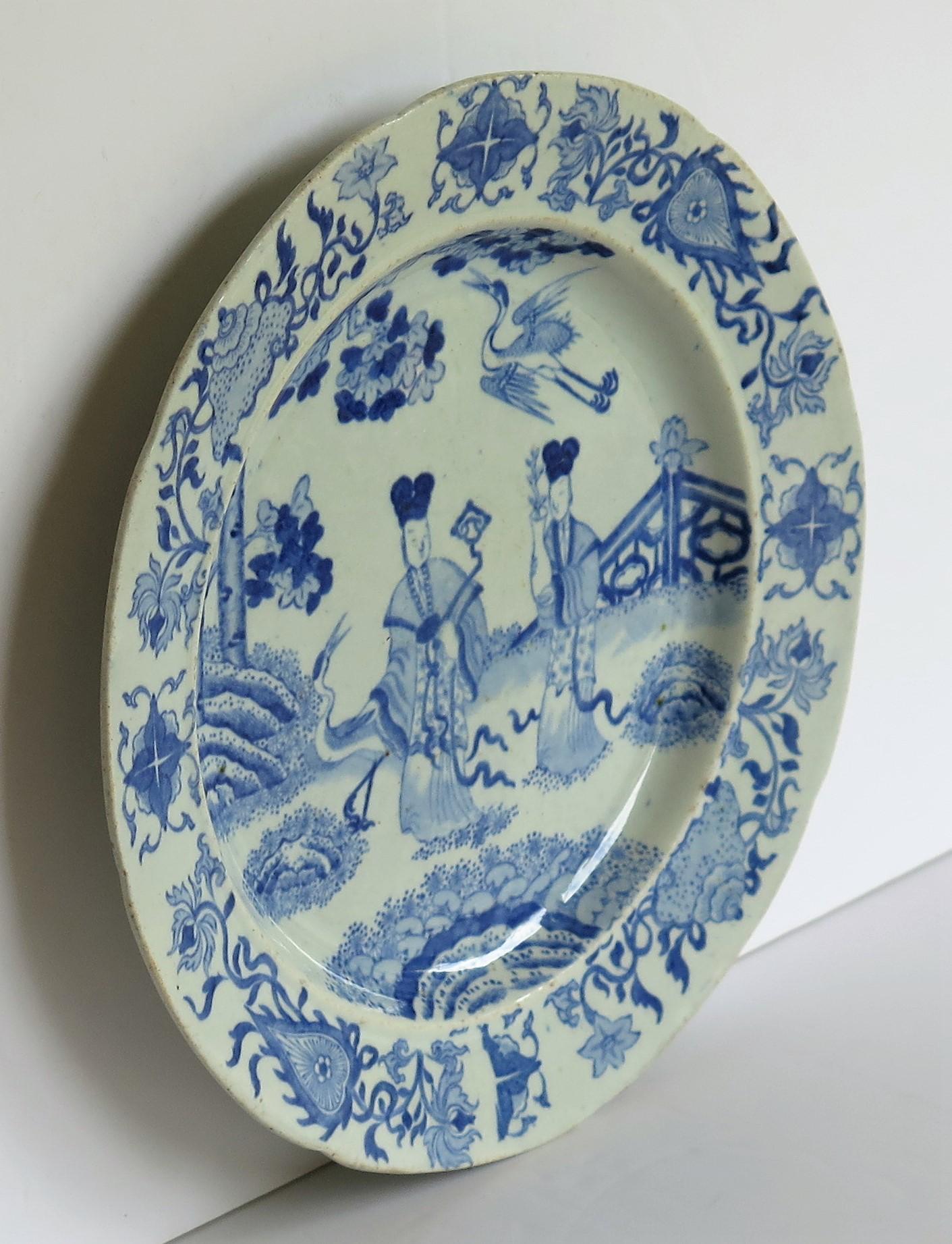 This ironstone pottery dinner plate was made by the Mason's factory at Lane Delph, Staffordshire, England and is decorated in the blue and white Chinese ladies with cranes which is a rare pattern, fully stamped and dating to the earliest period of