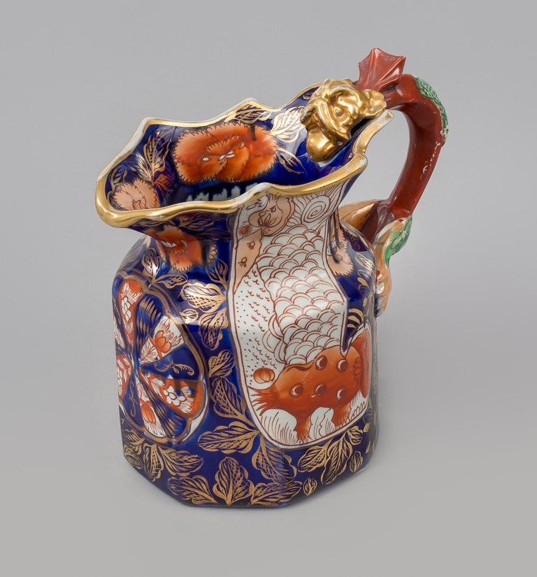 A Mason’s Ironstone China jug decorated in the “Elephant’s Foot” pattern, with well defined dragon handle with gilded head, glazed in the Imari colors of cobalt, orange and gilding. The base has the round impressed mark for Mason’s.