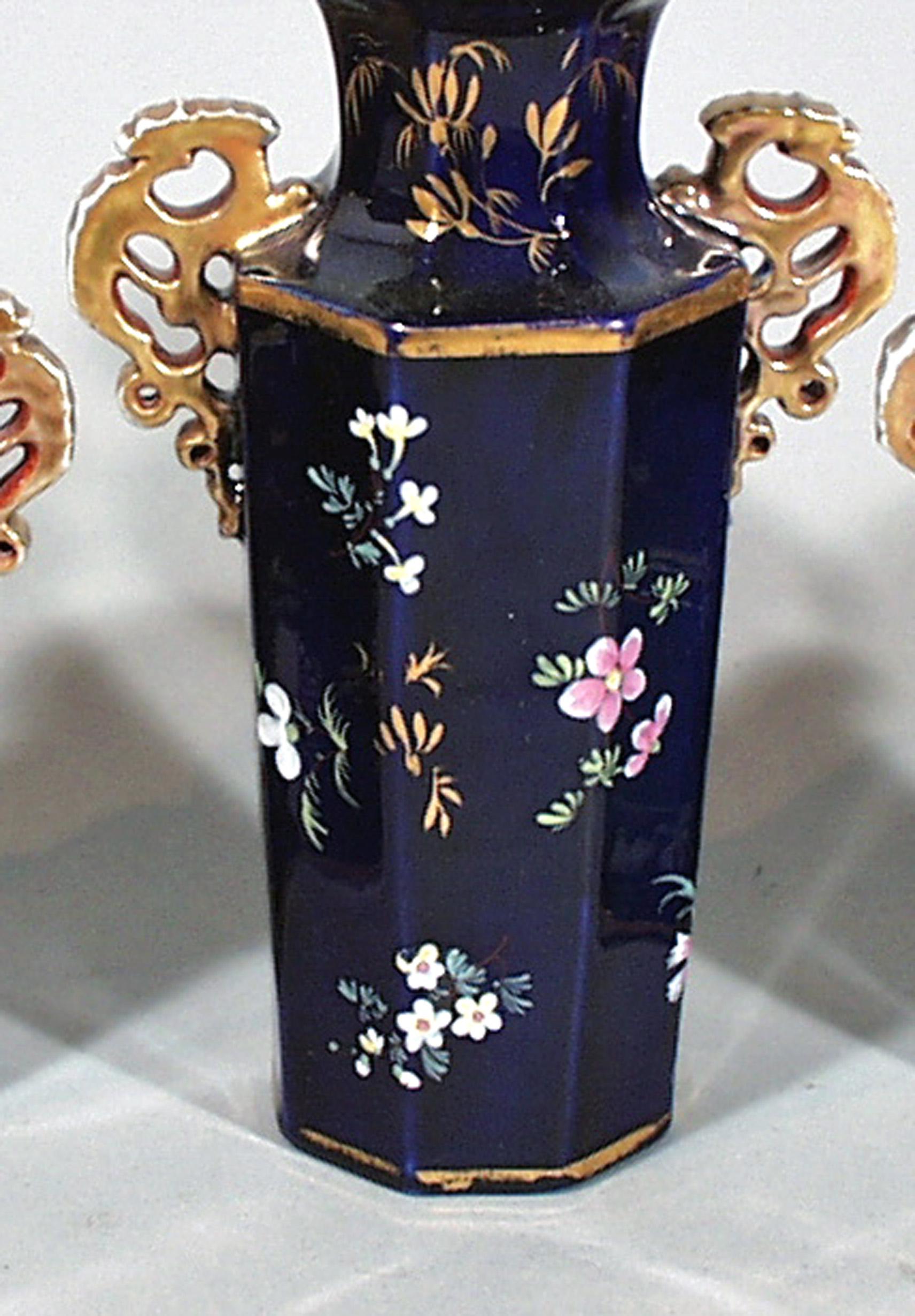Mason's Ironstone Garniture of Three vases,
circa 1835

The three hexagonal-shaped vases are painted with polychrome flowers on a mazarine blue ground. The open-work handles, rim and feet are gilded.

Dimensions: Height 7 inches and 5 3/4