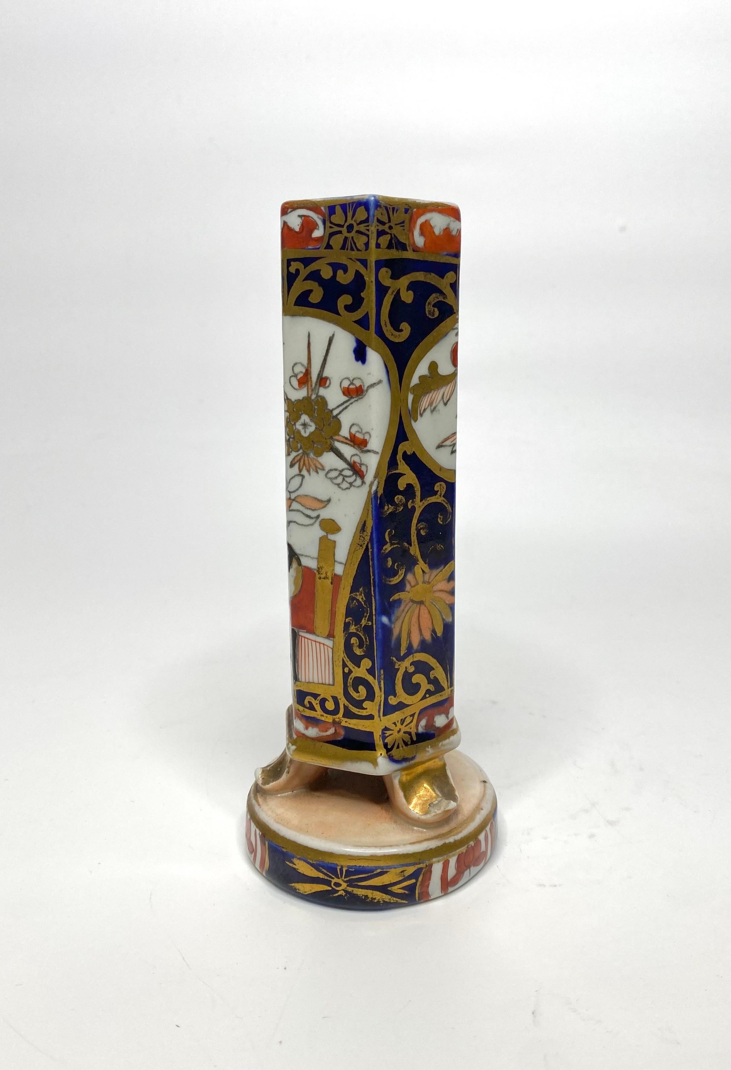 A rare Masons Ironstone pottery spill vase, c. 1820. The tall hexagonal shaped spill vase, vibrantly painted in Japanese Imari style, with a shaped panel containing a jardiniere of flowering plants, on a garden terrace. The reverse with a smaller