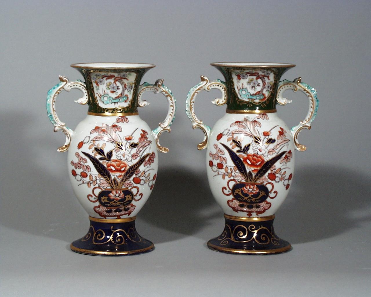 Mason's ironstone Japan pattern pair of vases,
circa 1830-1840.
 
The vases are decorated in an imari palette with scroll handles highlighted in turquoise and gilt. The circular flaring foot is in a mazarine blue ground with gilt highlights. The