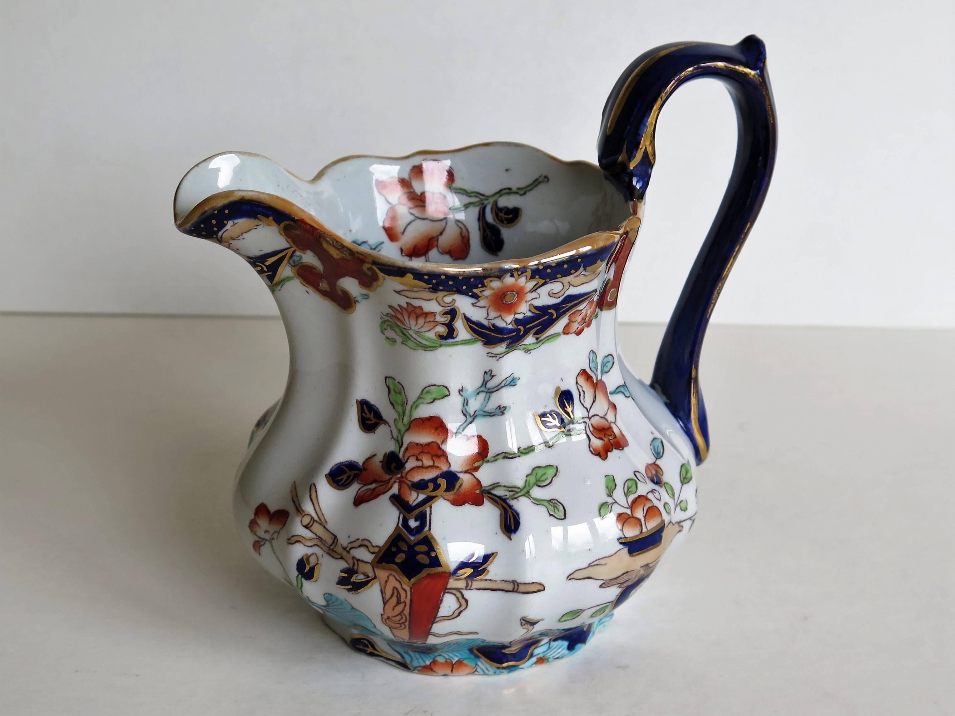 This is a very good jug or pitcher by Mason's Ironstone, England, circa 1890.

The jug has a bulbous fluted form in a shape that is not often seen and with a high loop handle having a thumb spur. 

This jug has one of the very decorative