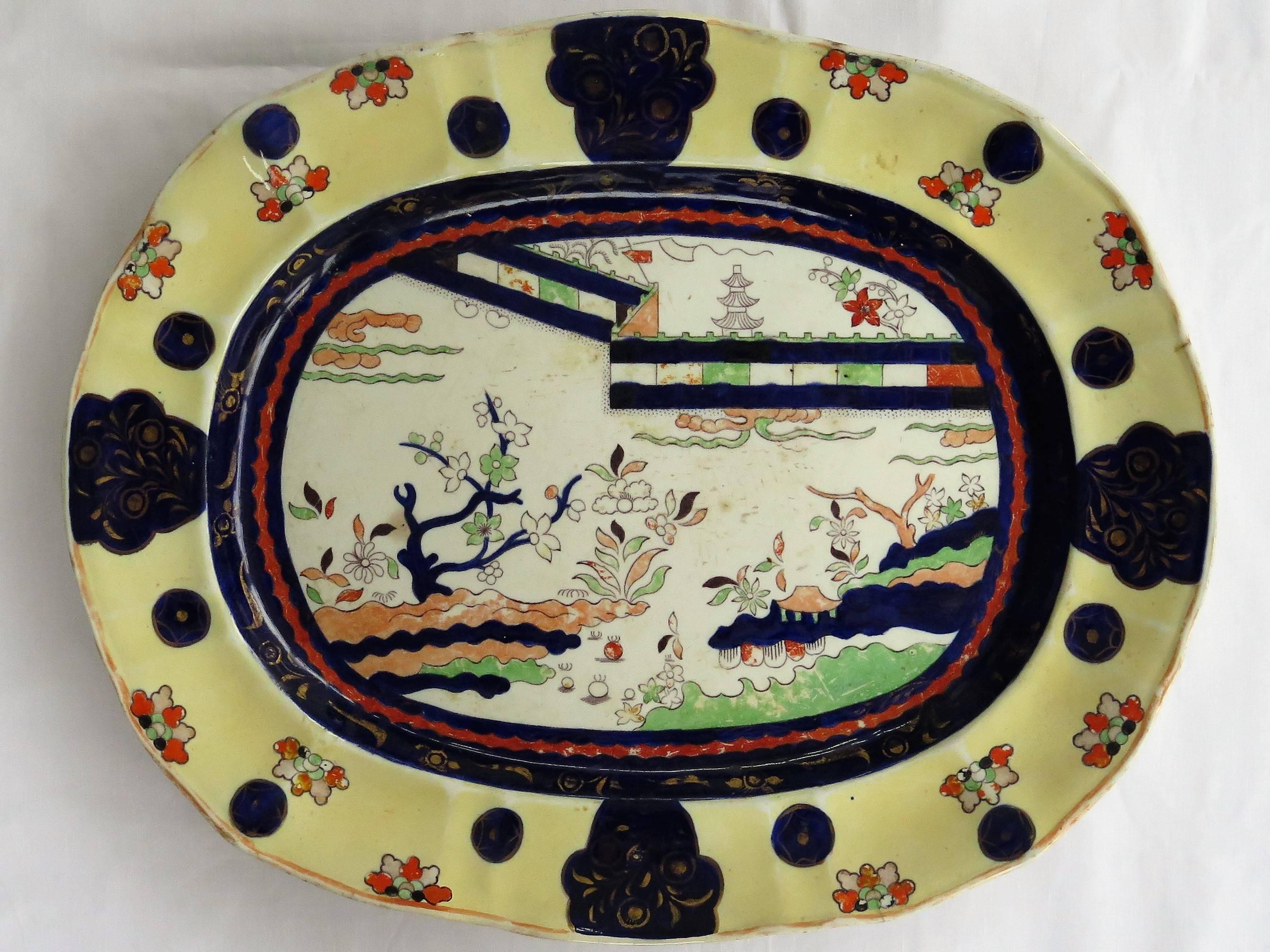 This is a very large mid-19th century Mason's ironstone Platter in the documented colored wall pattern, made in the mid-19th century, circa 1840. 

This large meat platter is decorated in a very bold chinoiserie pattern called the 